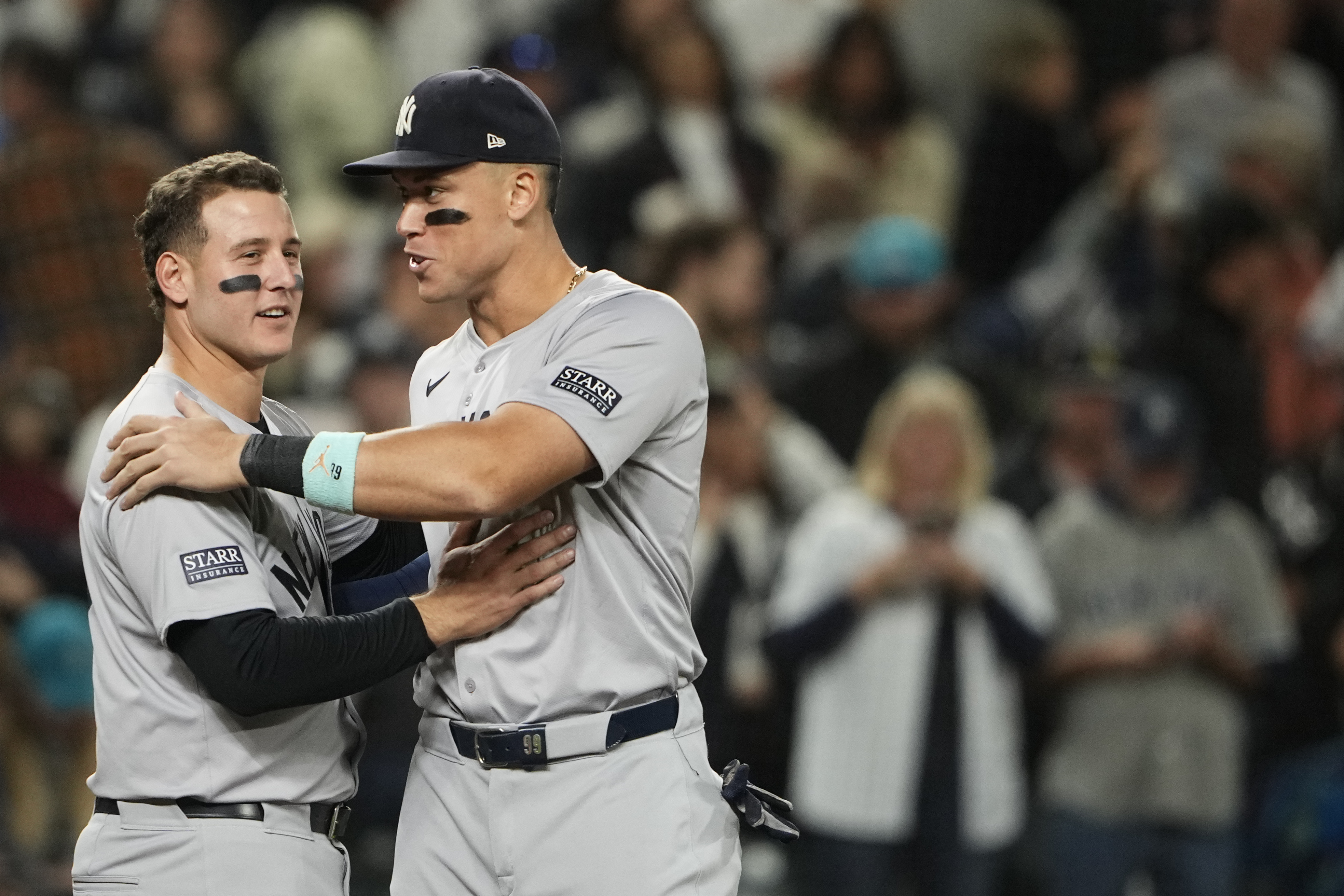 New York Yankees' Anthony Rizzo, left, greets designated hitter Aaron Judge, right, as they celebrate clinching a playoff spot after a 2-1 win over the Seattle Mariners in a baseball game Wednesday, Sept. 18, 2024, in Seattle.