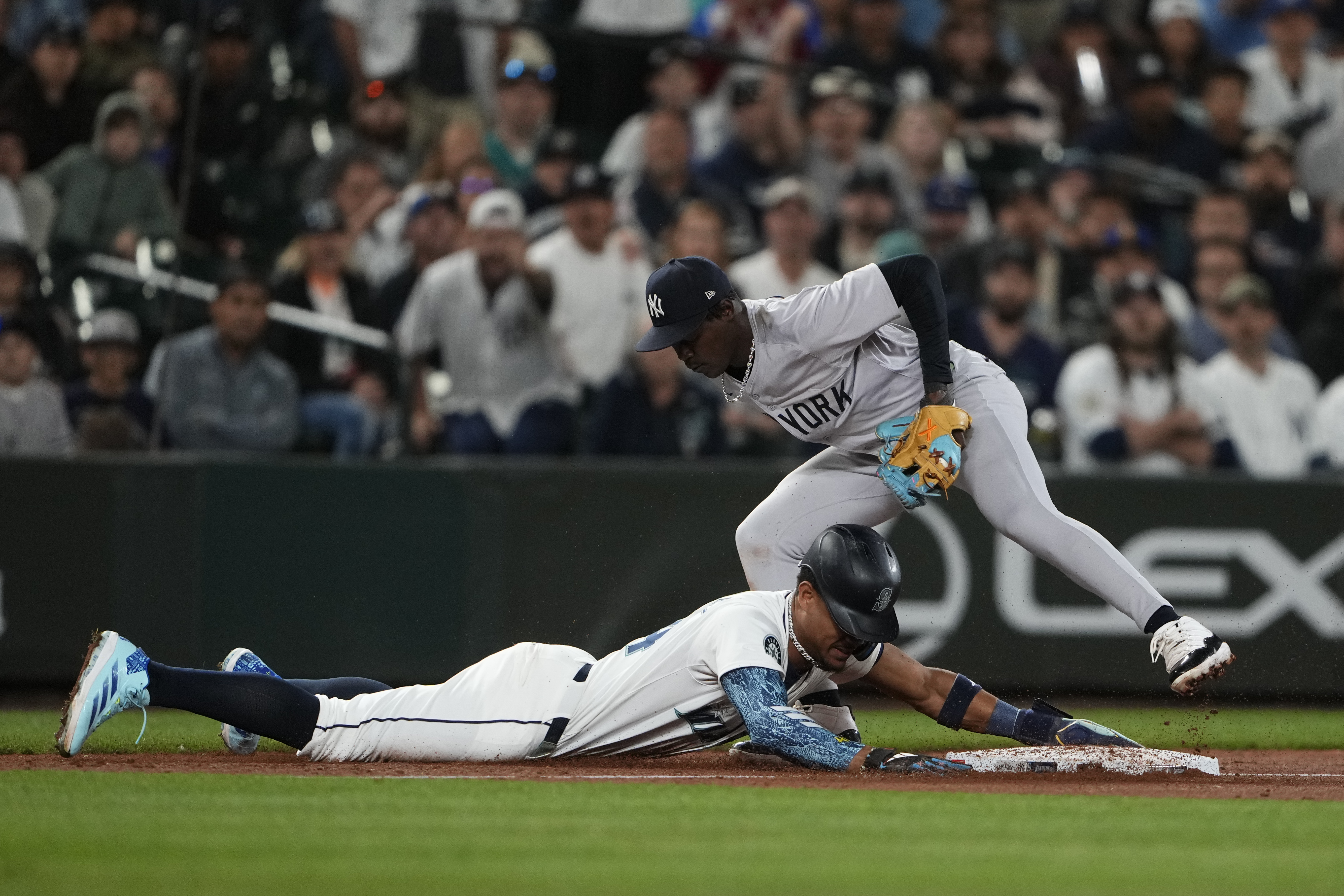 Seattle Mariners' Julio Rodríguez is picked off at third base by New York Yankees third baseman Jazz Chisholm Jr. after Mariners' Randy Arozarena lost his bat on a swing during the 10th inning of a baseball game Wednesday, Sept. 18, 2024, in Seattle.
