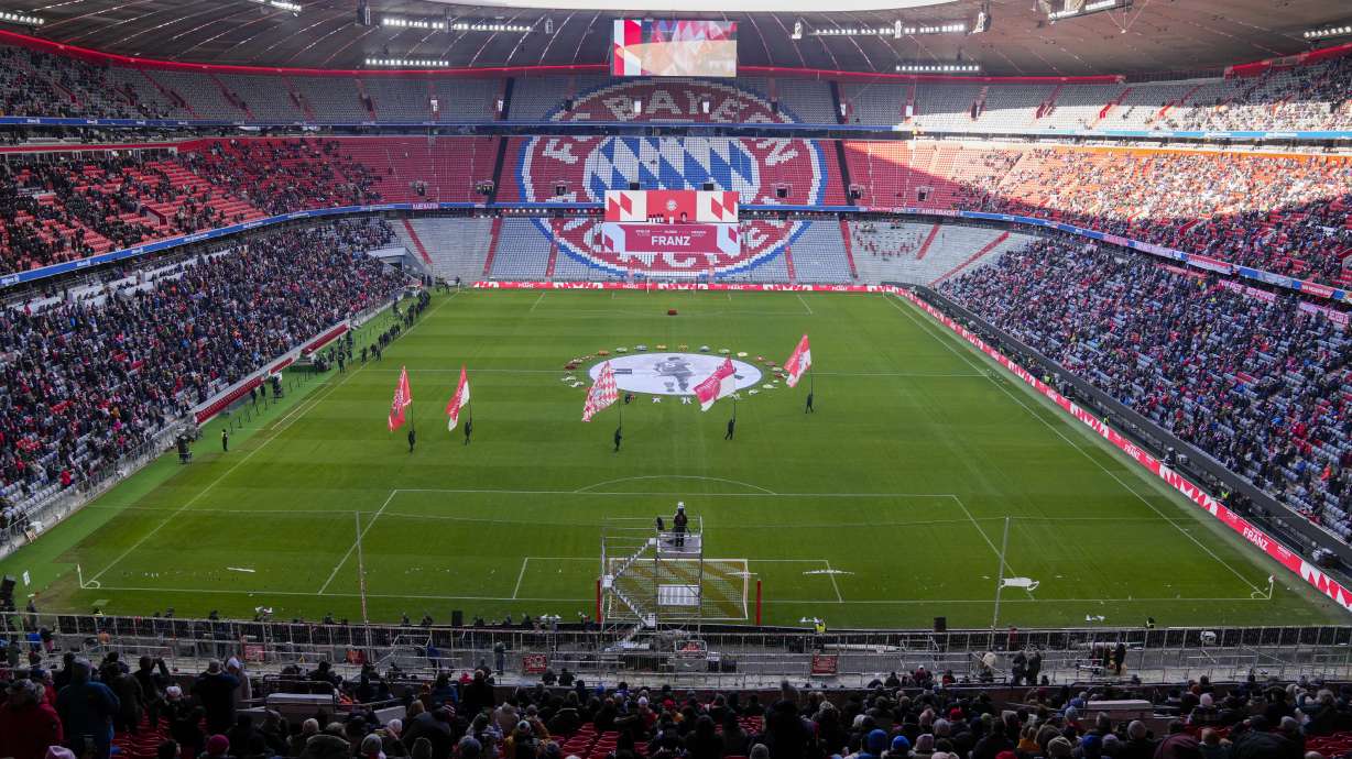 FILE - Flower wreaths surround a photograph of Bayern and Germany legend Franz Beckenbauer on the pitch of the Allianz Arena in Munich, Germany, Friday, Jan. 19, 2024, before a memorial service.