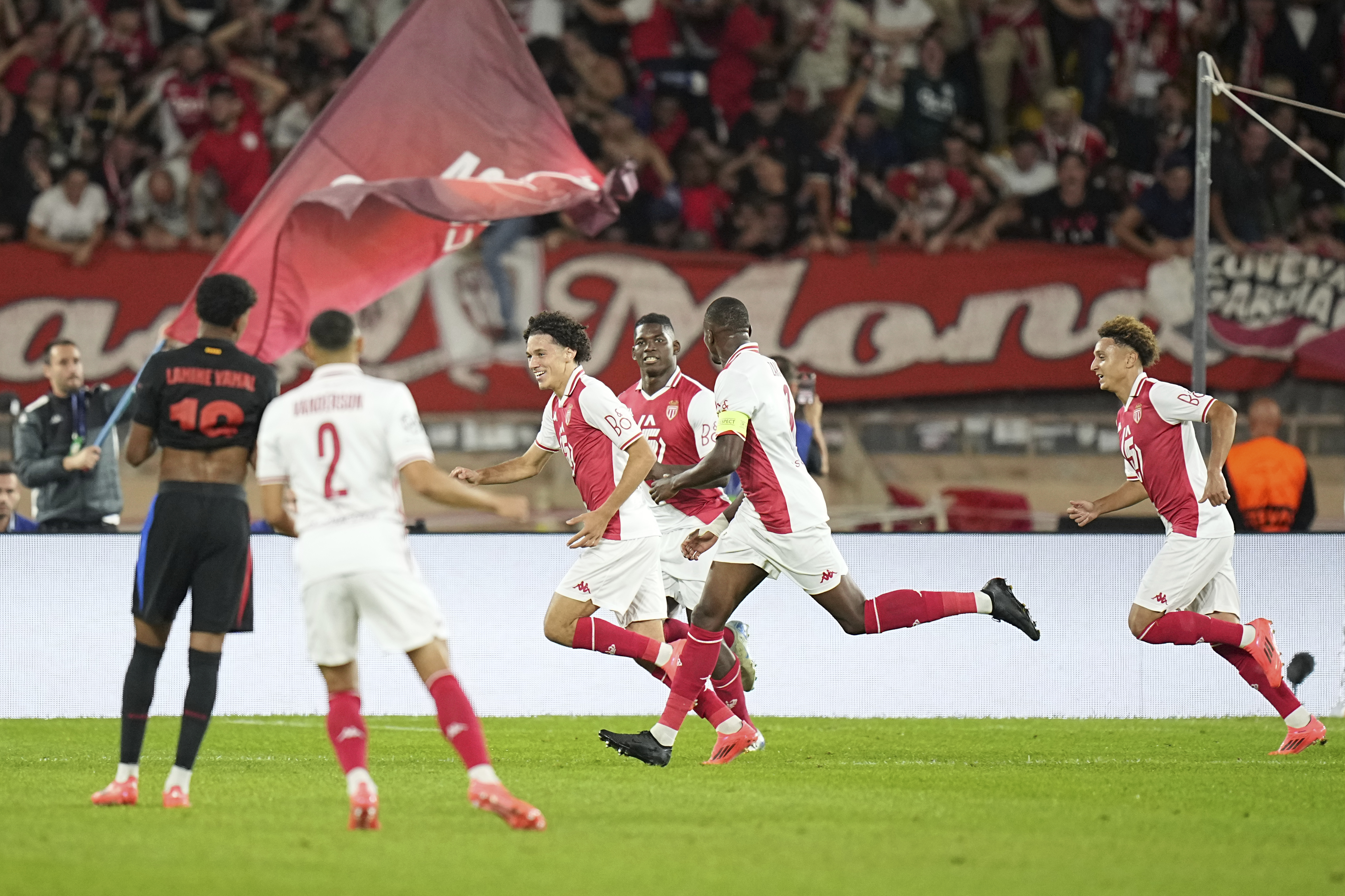 Monaco's Maghnes Akliouche, third left, celebrates after scoring his side's opening goal during the Champions League opening phase soccer match between Monaco and Barcelona at the Louis II stadium, in Monaco, Monaco, Thursday, Sept. 19, 2024.