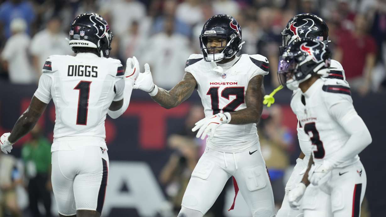 Houston Texans wide receiver Nico Collins (12) is congratulated by Stefon Diggs (1) after catching a touchdown pass during the first half of an NFL football game against the Chicago Bears Sunday, Sept. 15, 2024, in Houston.