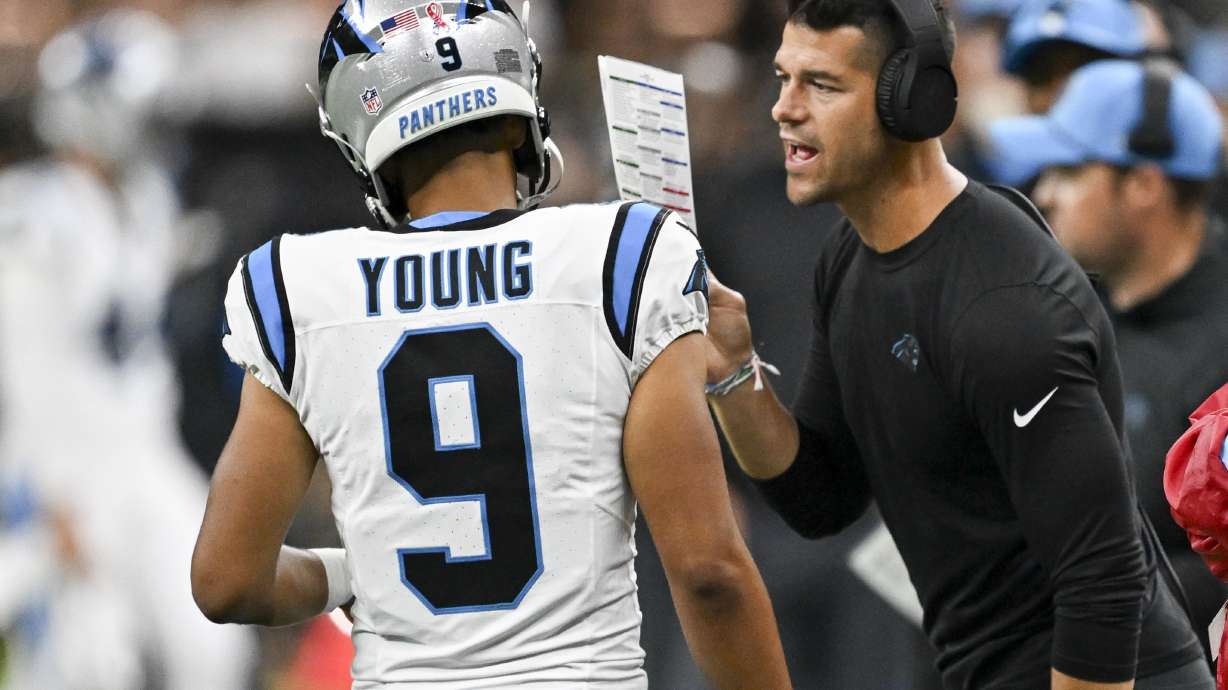Carolina Panthers head coach Dave Canales right talks to quarterback Bryce Young (9) during the second half of an NFL football game against the New Orleans Saints, Sunday, Sept. 8, 2024, in New Orleans.