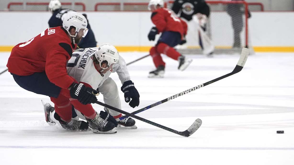 Florida Panthers defenseman Aaron Ekblad (5) and left wing Matthew Tkachuk (19) battle for the puck during NHL hockey training camp Thursday, Sept. 19, 2024, in Fort Lauderdale, Fla.