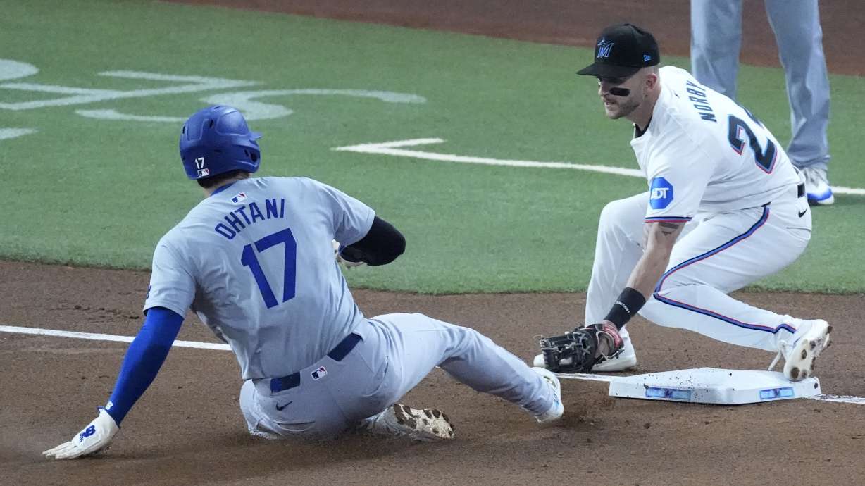 Los Angeles Dodgers' Shohei Ohtani (17) of Japan, steals third base, for his 50th stolen base of the season, as Miami Marlins third baseman Connor Norby attempts the tag during the first inning of a baseball game, Thursday, Sept. 19, 2024, in Miami.