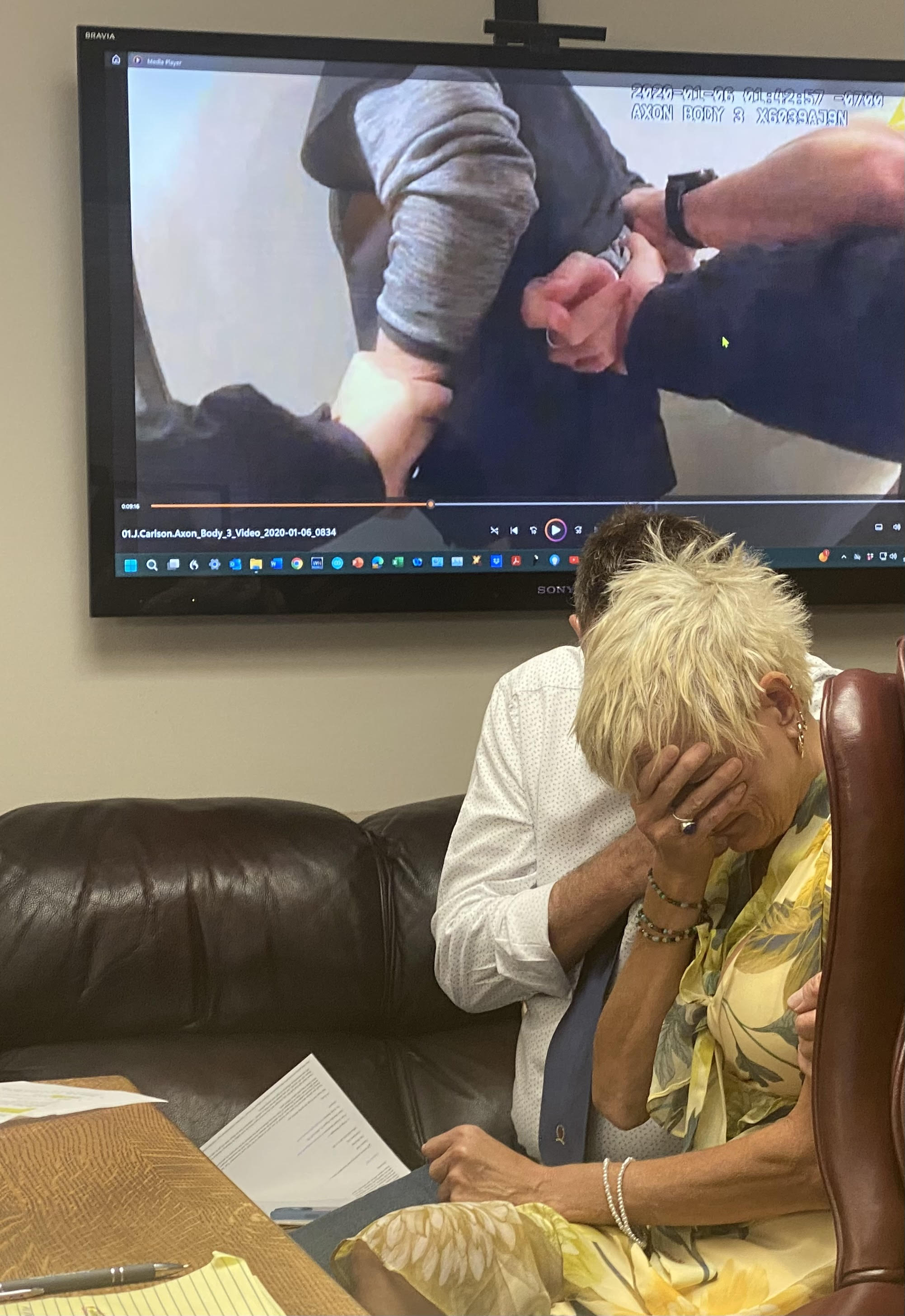 Danyale Blackmore, co-owner of My Place Hotel in Hurricane, buries her face in her palm as body camera video from her 2020 arrest is played during a press conference Thursday. She and her husband, Vincent Blackmore, have filed a second lawsuit against Hurricane city officials. 