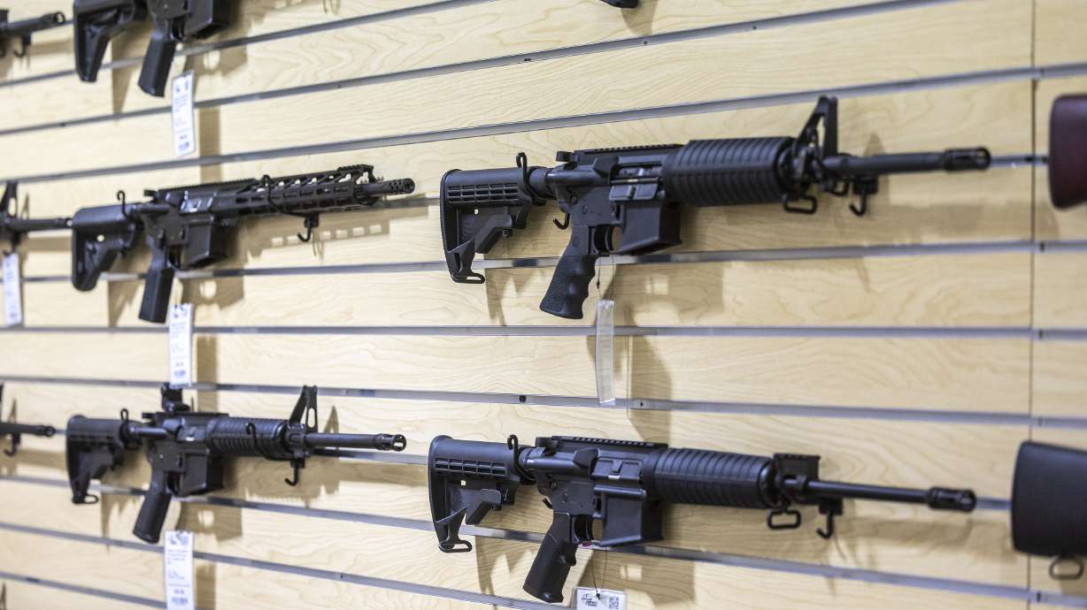 AR-15 rifles are displayed at Impact Guns on July 6, 2022. A proposed bill would allow 18- to 20-year-olds to openly carry firearms in most public spaces in Utah and prevent landlords from enforcing lease agreements that bar firearms from the premises.