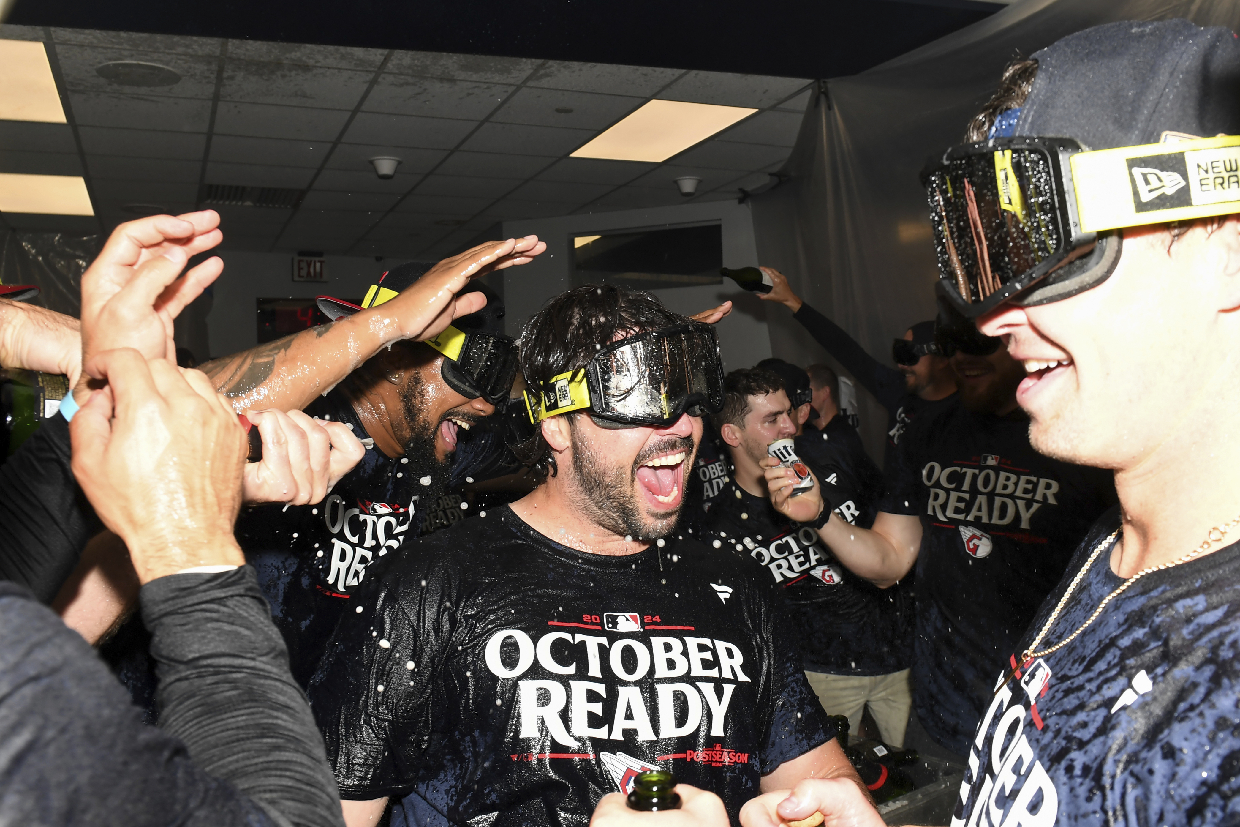 The Cleveland Guardians, including Austin Hedges, center, celebrate after their 10-inning win over the Minnesota Twins in a baseball game to clinch a playoff berth Thursday, Sept. 19, 2024, in Cleveland.