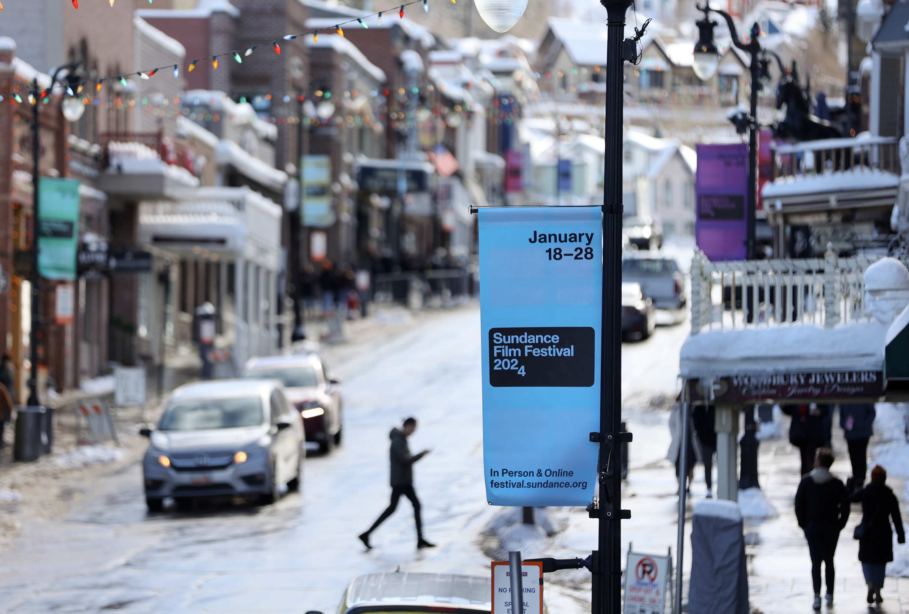 Signs are posted for the 2024 Sundance Film Festival on Main Street in Park City on Jan. 18. Gov. Spencer Cox said he's "optimistic" about Utah's chances to keep the festival beyond 2026. 