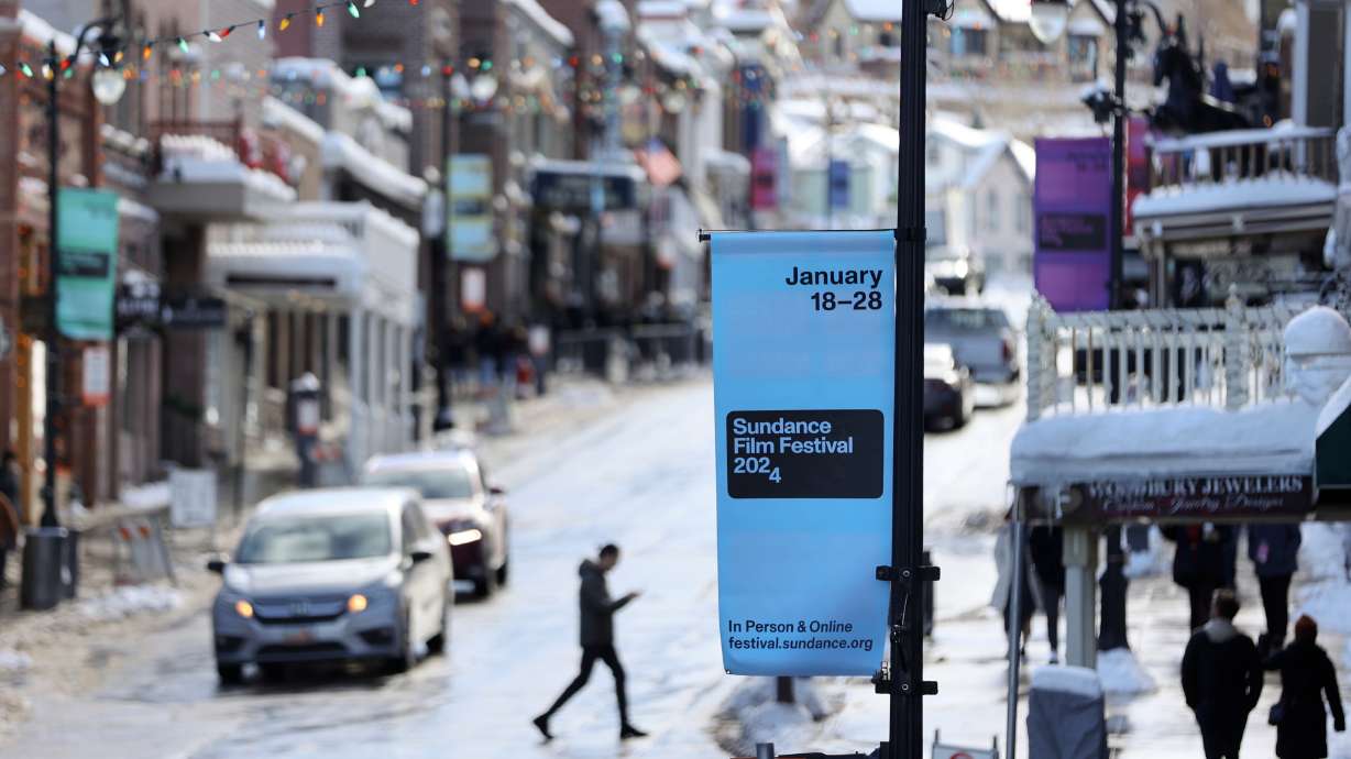 Signs are posted for the 2024 Sundance Film Festival on Main Street in Park City on Jan. 18. Gov. Spencer Cox said he's "optimistic" about Utah's chances to keep the festival beyond 2026.