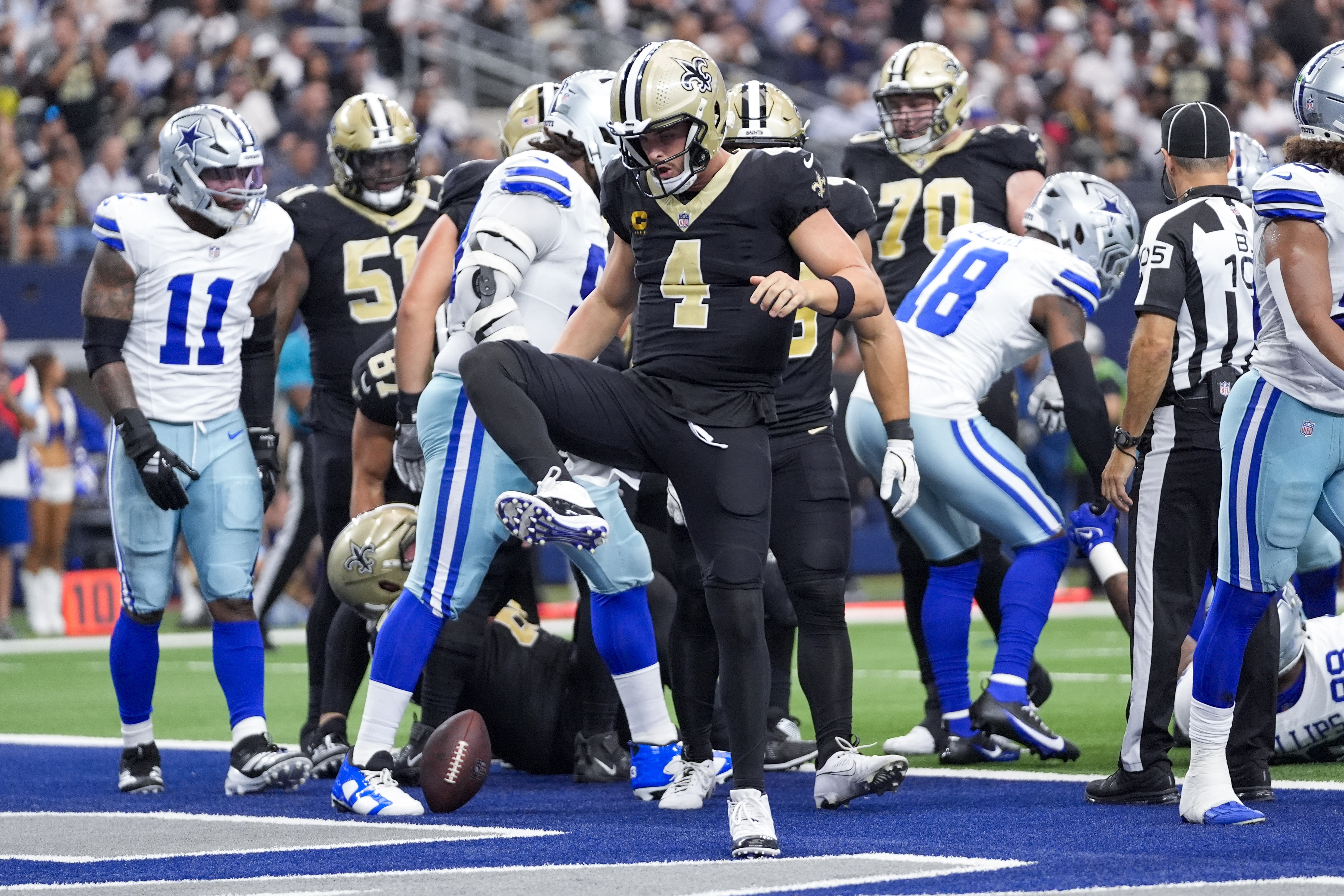 New Orleans Saints quarterback Derek Carr reacts after scoring on a keeper against the Dallas Cowboys during the first half of an NFL football game, Sunday, Sept. 15, 2024, in Arlington, Texas.