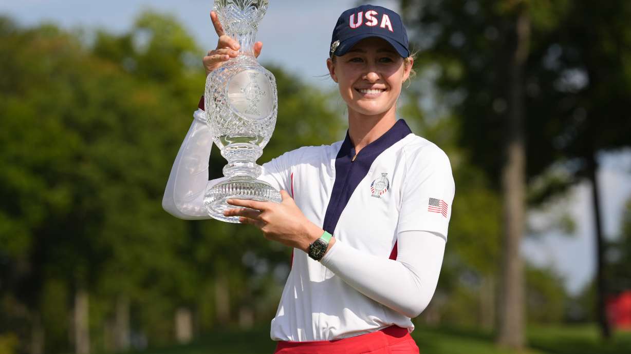 United States' Nelly Korda holds the winner's trophy after the United States defeated Europe in the Solheim Cup golf tournament at the Robert Trent Jones Golf Club, Sunday, Sept. 15, 2024, in Gainesville, Va.