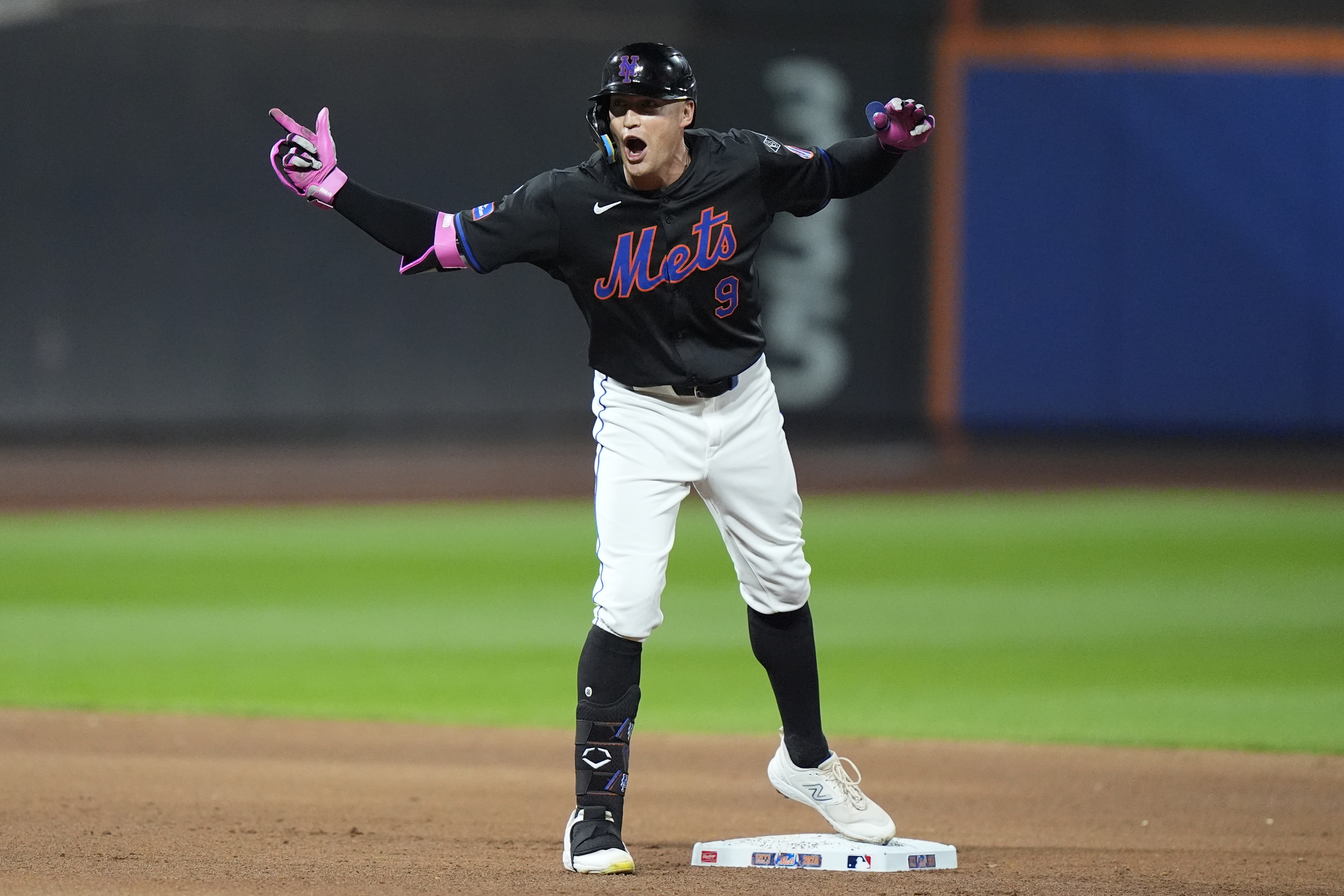 New York Mets' Brandon Nimmo (9) gestures to teammates after hitting an RBI double during the fourth inning of a baseball game against the Philadelphia Phillies, Thursday, Sept. 19, 2024, in New York.