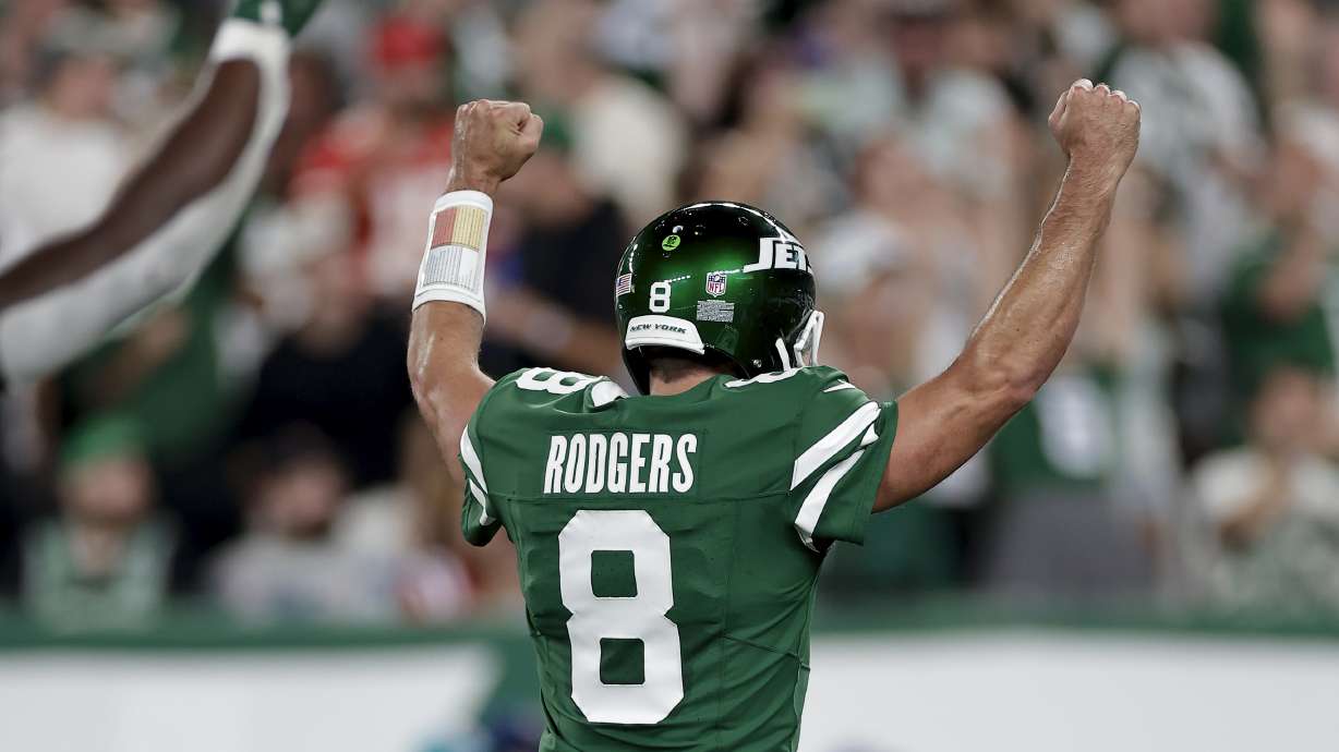 New York Jets quarterback Aaron Rodgers (8) reacts after throwing a touchdown pass against the New England Patriots during the first quarter of an NFL football game, Thursday, Sept. 19, 2024, in East Rutherford, N.J.