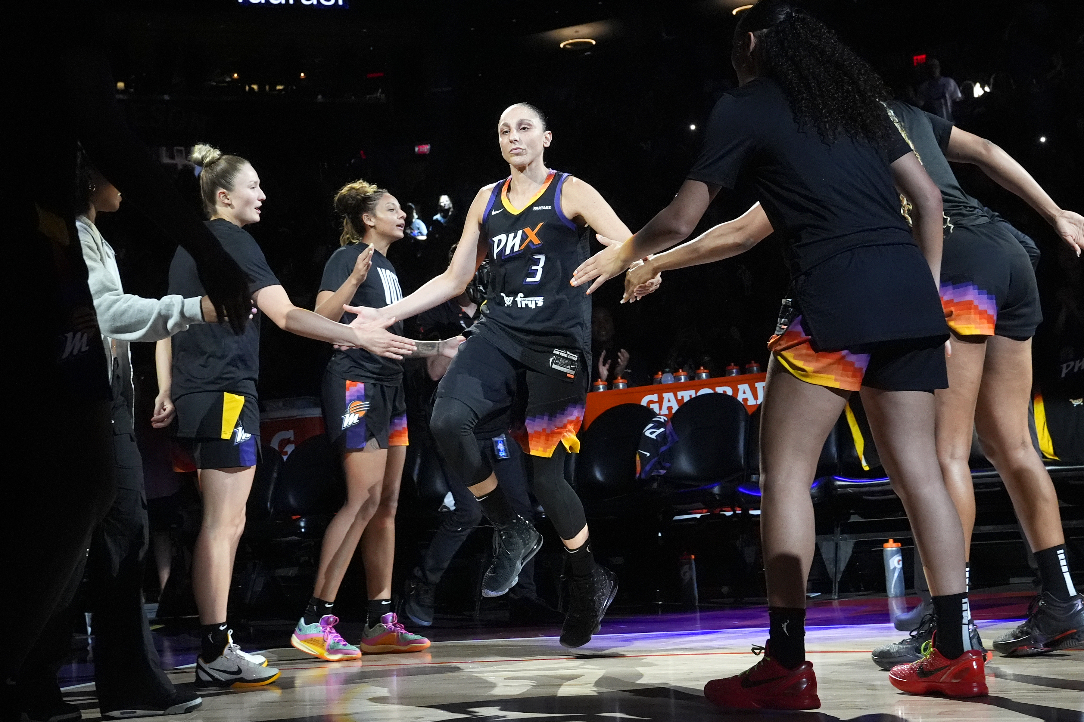 Phoenix Mercury guard Diana Taurasi (3) slaps hands with teammates during player introductions prior to a WNBA basketball game against the Seattle Storm, Thursday, Sept. 19, 2024, in Phoenix.