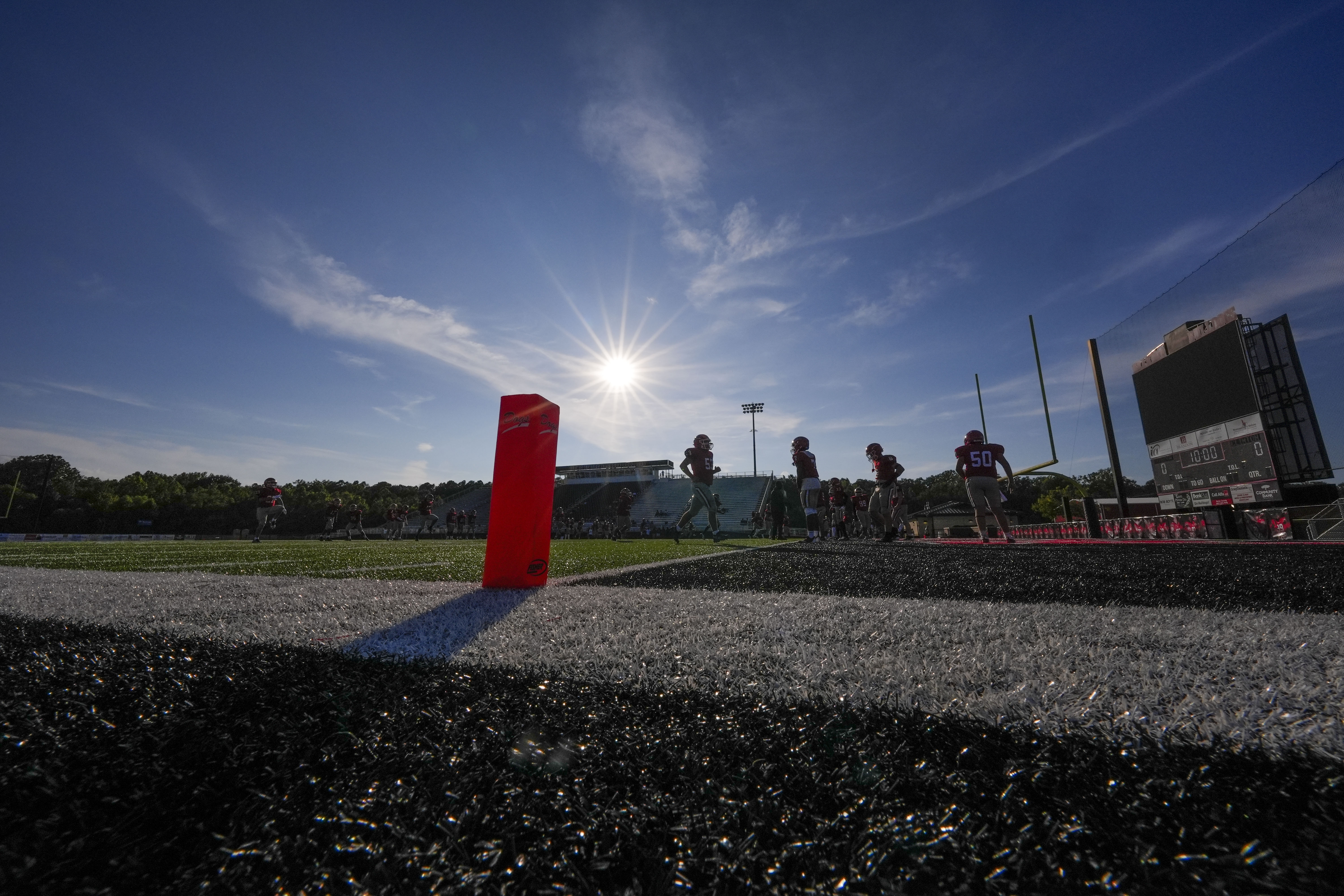 Members of the Brandon High freshman football team warm up before a game against Clinton High in Brandon, Miss., Tuesday, Aug. 27, 2024.