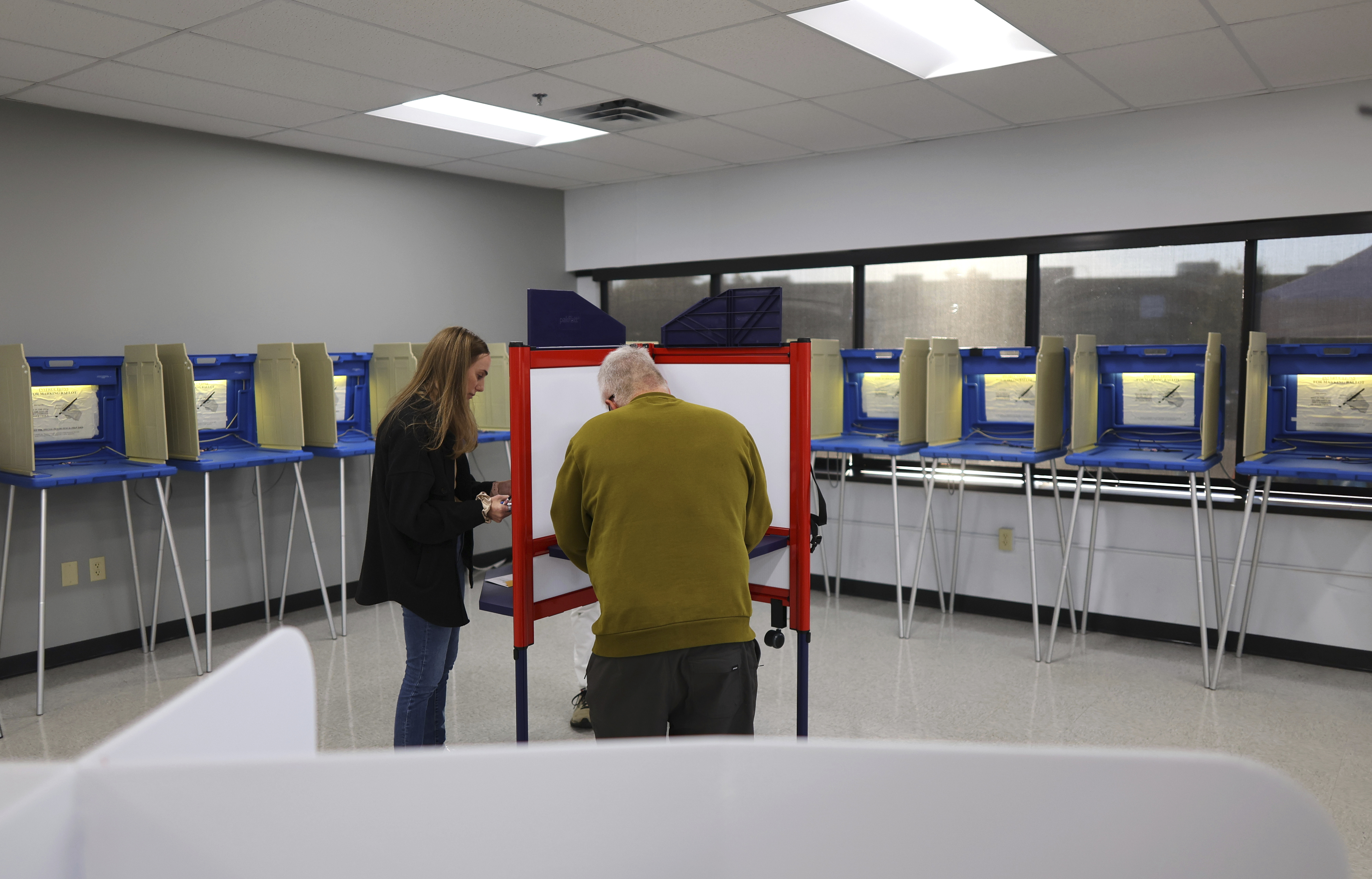 Minneapolis residents cast their votes at the City of Minneapolis early voting center, Friday, in Minneapolis, Minn.
