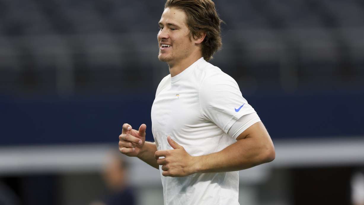 Los Angeles Chargers quarterback Justin Herbert warms up before a preseason NFL football game against the Dallas Cowboys, Saturday, Aug. 24, 2024, in Arlington, Texas.