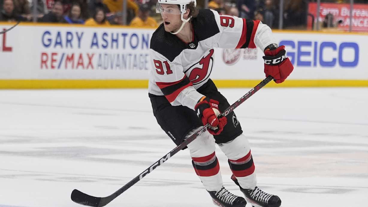 FILE - New Jersey Devils center Dawson Mercer (91) skates with the puck during the third period of an NHL hockey game against the Nashville Predators, Tuesday, Feb. 13, 2024, in Nashville, Tenn.