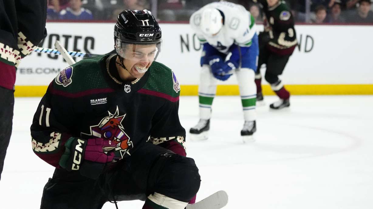 FILE - Arizona Coyotes right wing Dylan Guenther (11) celebrates his goal against the Vancouver Canucks during the third period of an NHL hockey game Wednesday, April 3, 2024, in Tempe, Ariz.