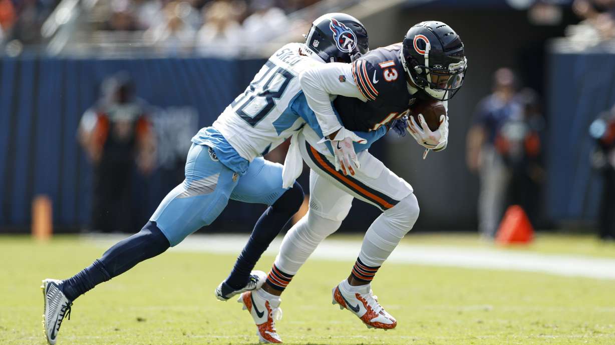 Chicago Bears wide receiver Keenan Allen (13) is tackled by Tennessee Titans cornerback L'Jarius Sneed (38) during the first half of an NFL football game, Sunday, Sept. 8, 2024, in Chicago.