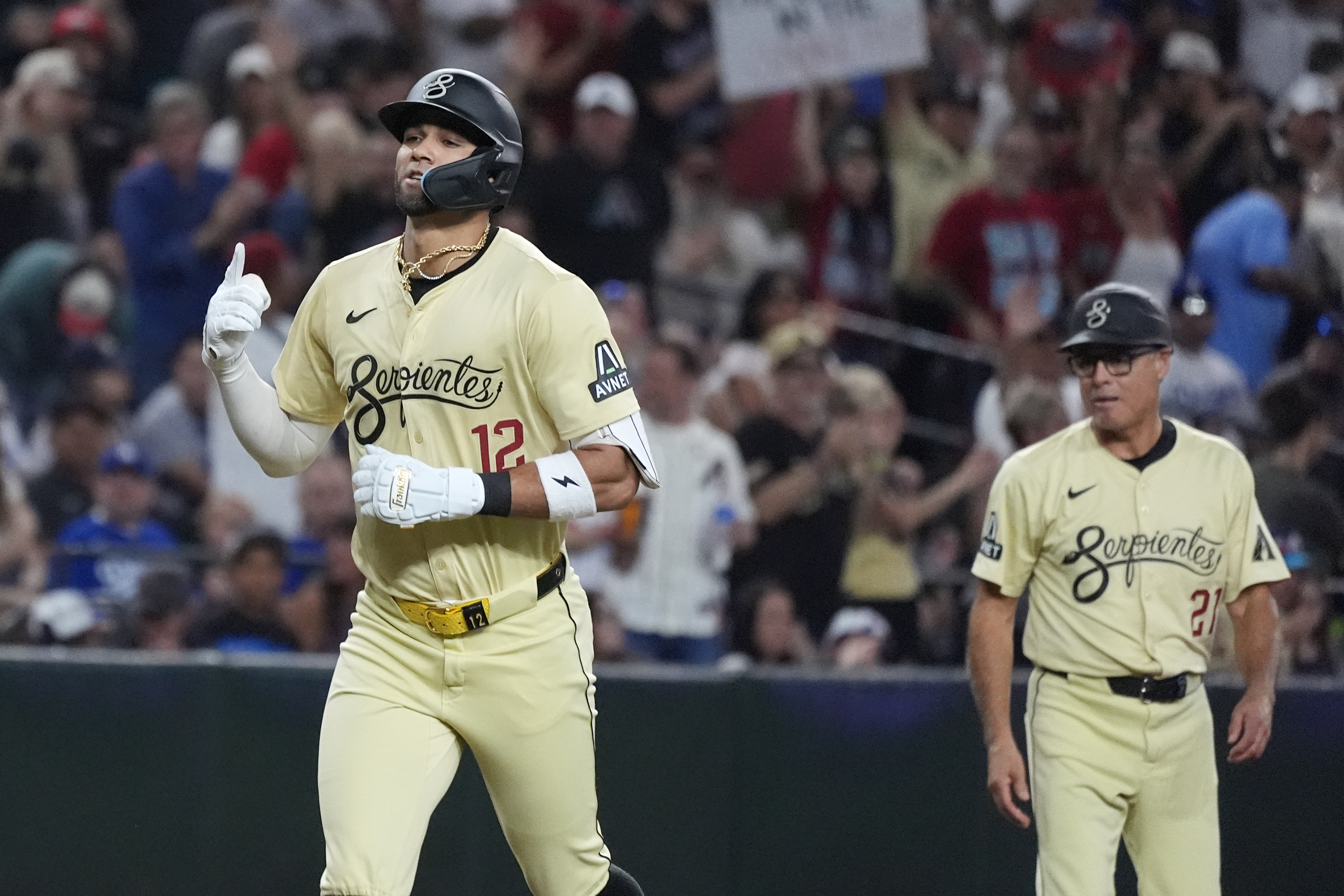 Arizona Diamondbacks' Lourdes Gurriel Jr. (12) rounds the bases after hitting a home run against the Los Angeles Dodgers as Diamondbacks third base coach Tony Perezchica, right, looks on during the third inning of a baseball game Saturday, Aug. 31, 2024, in Phoenix.