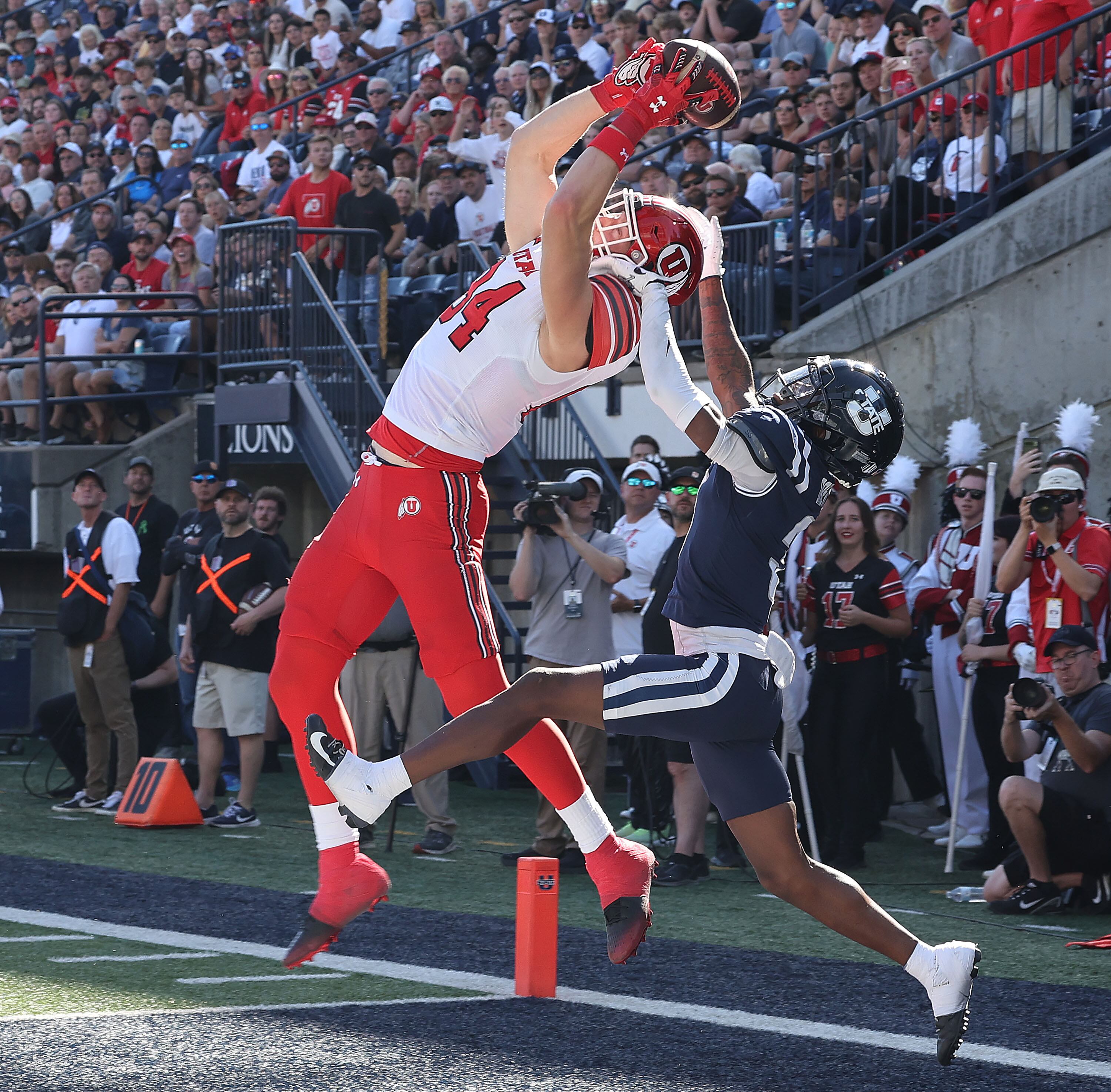 Utah Utes tight end Caleb Lohner (84) scores against Utah State Aggies cornerback JD Drew (3) in Logan on Sept. 14.