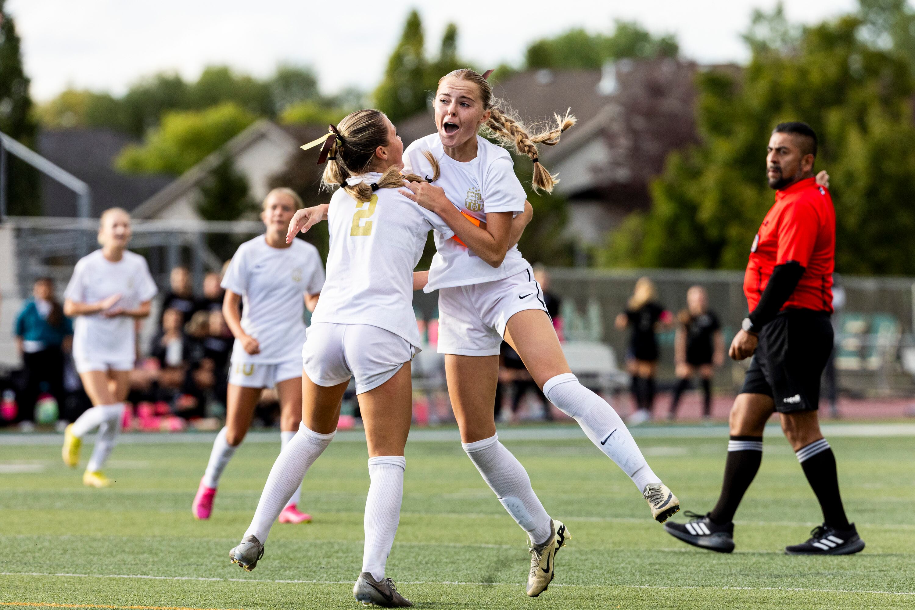 Davis' Cadence Packer (3) celebrates her goal against Farmington with her sister Simone Packer (2) during a game held at Farmington High School in Farmington on Sept. 17.