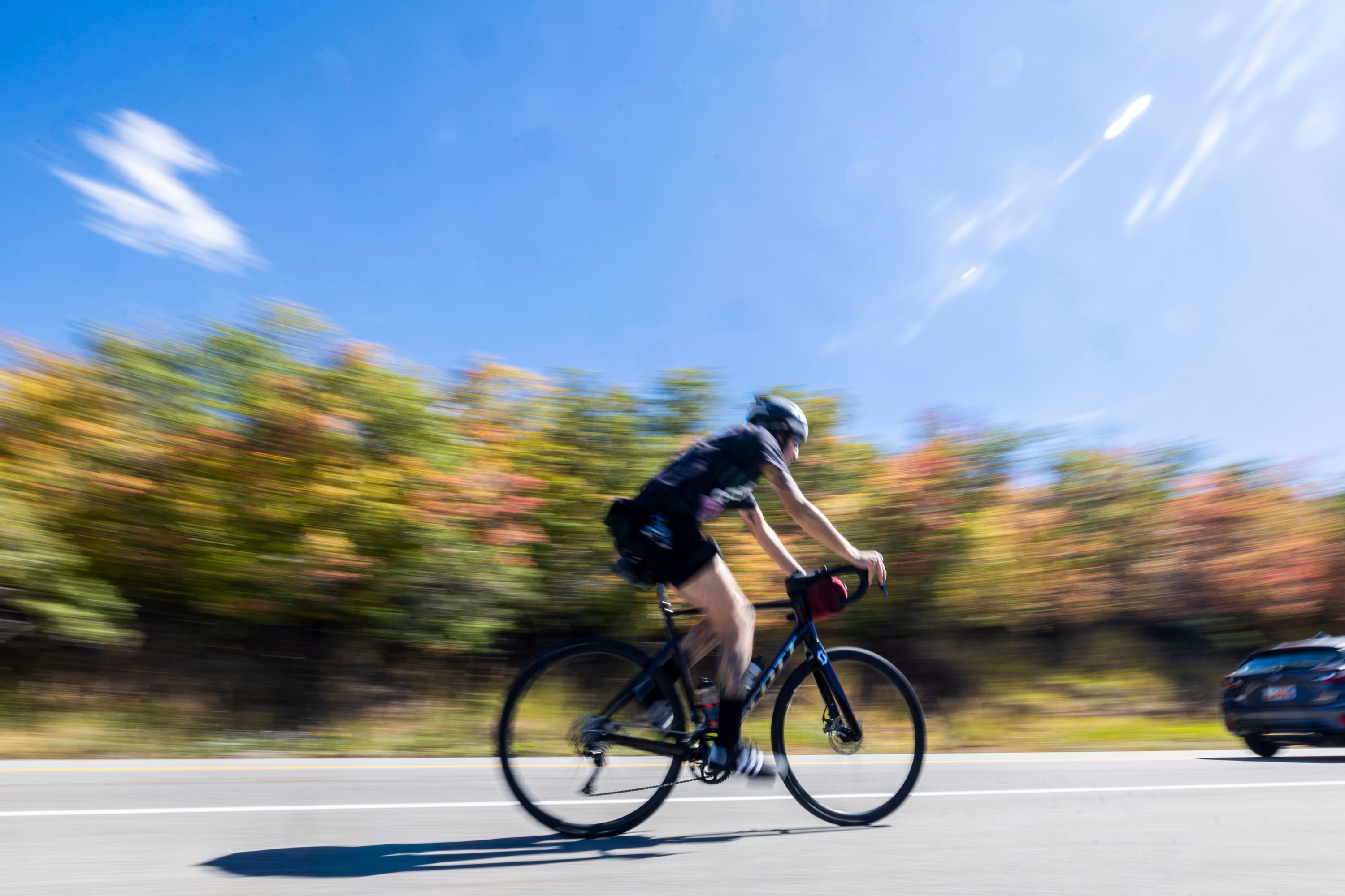 A cyclist rides along Emigration Canyon Road as fall colors begin to show themselves in the trees of Emigration Canyon east of Salt Lake City on Sept. 19.