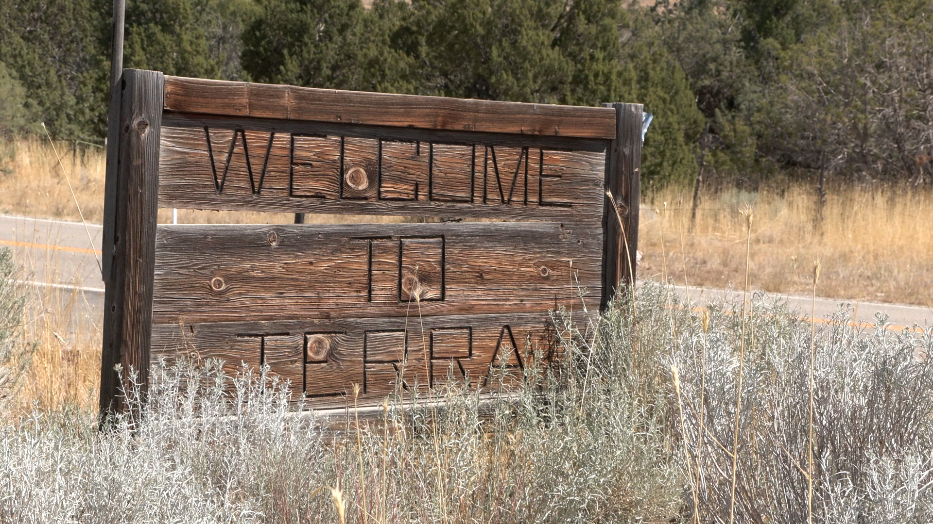 Wooden sign reads “Welcome to Terra.”