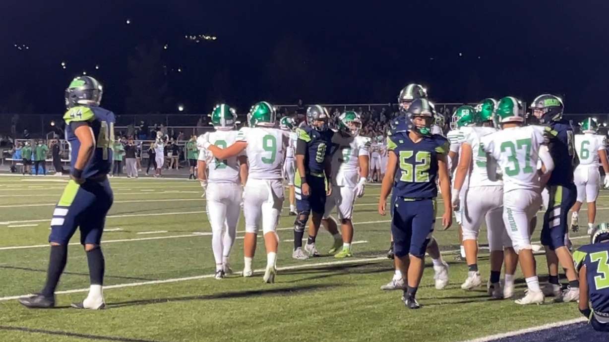Provo's Oliver Mackay (8) celebrates a short touchdown run with Mason Gregory (9) against Timpanogos during a Utah high school football game, Friday, Sept. 20, 2024 at Timpanogos High School in Orem, Utah.