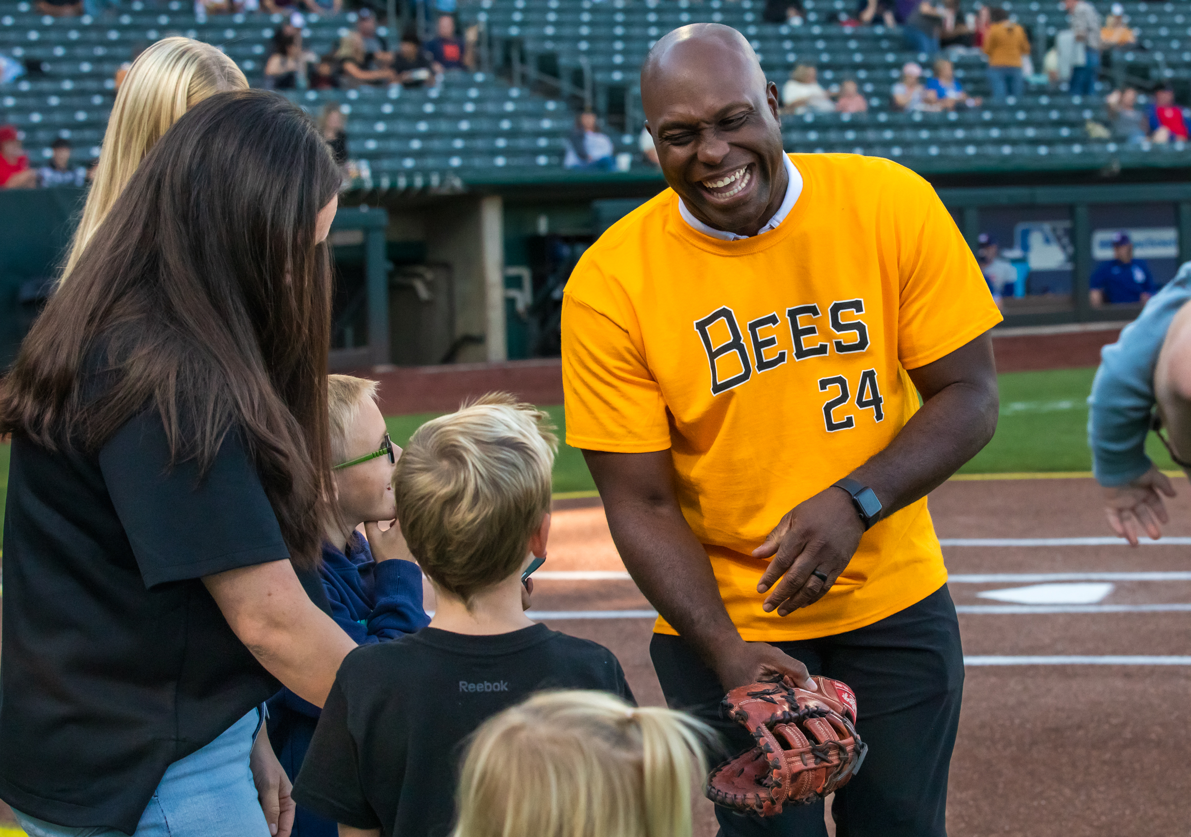 Former MLB star Torii Hunter, right, shares a laugh with Jaxon LeBaron as he coaches him on a first pitch before the Salt Lake Bees game at Smith's Ballpark on Friday. Hunter is one of many players who once played at the ballpark, which the Bees are moving out of after Sunday.