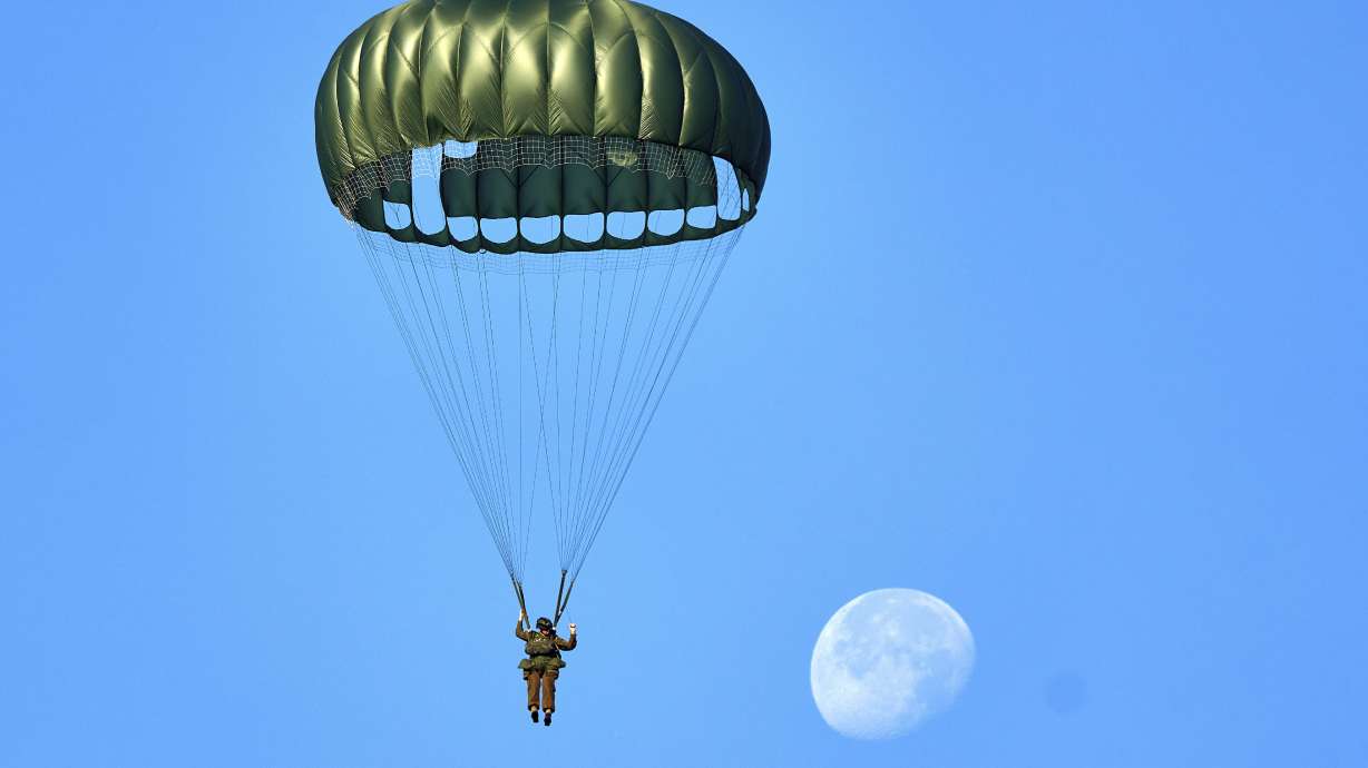 Parachutists jump over Ginkel Heath Netherlands Saturday, to mark the 80th anniversary of an audacious but unsuccessful World War II mission codenamed Market Garden to take key bridges in the Netherlands.