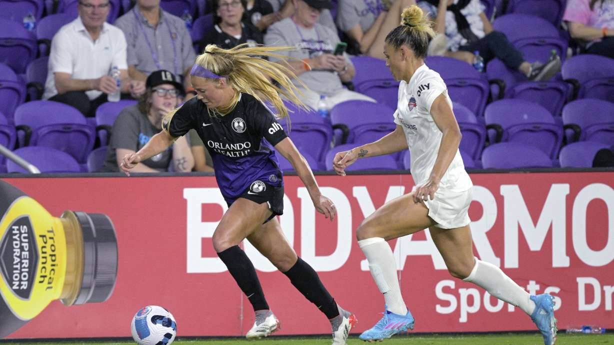 FILE - Orlando Pride midfielder Mikayla Cluff, left, controls the ball in front of Washington Spirit forward Trinity Rodman during an NWSL Challenge Cup soccer match March 19, 2022, in Orlando, Fla.