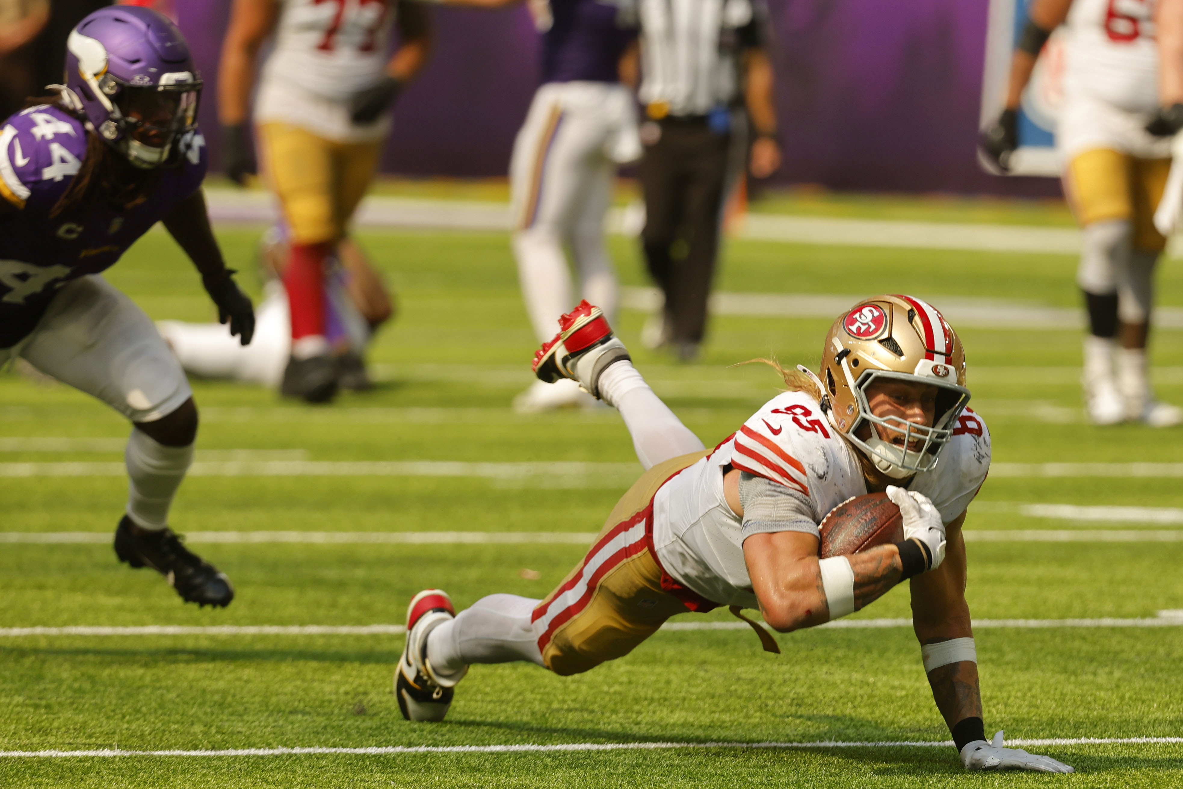 San Francisco 49ers tight end George Kittle (85) dives for extra yardage after catching a pass during the second half of an NFL football game against the Minnesota Vikings, Sunday, Sept. 15, 2024, in Minneapolis. 