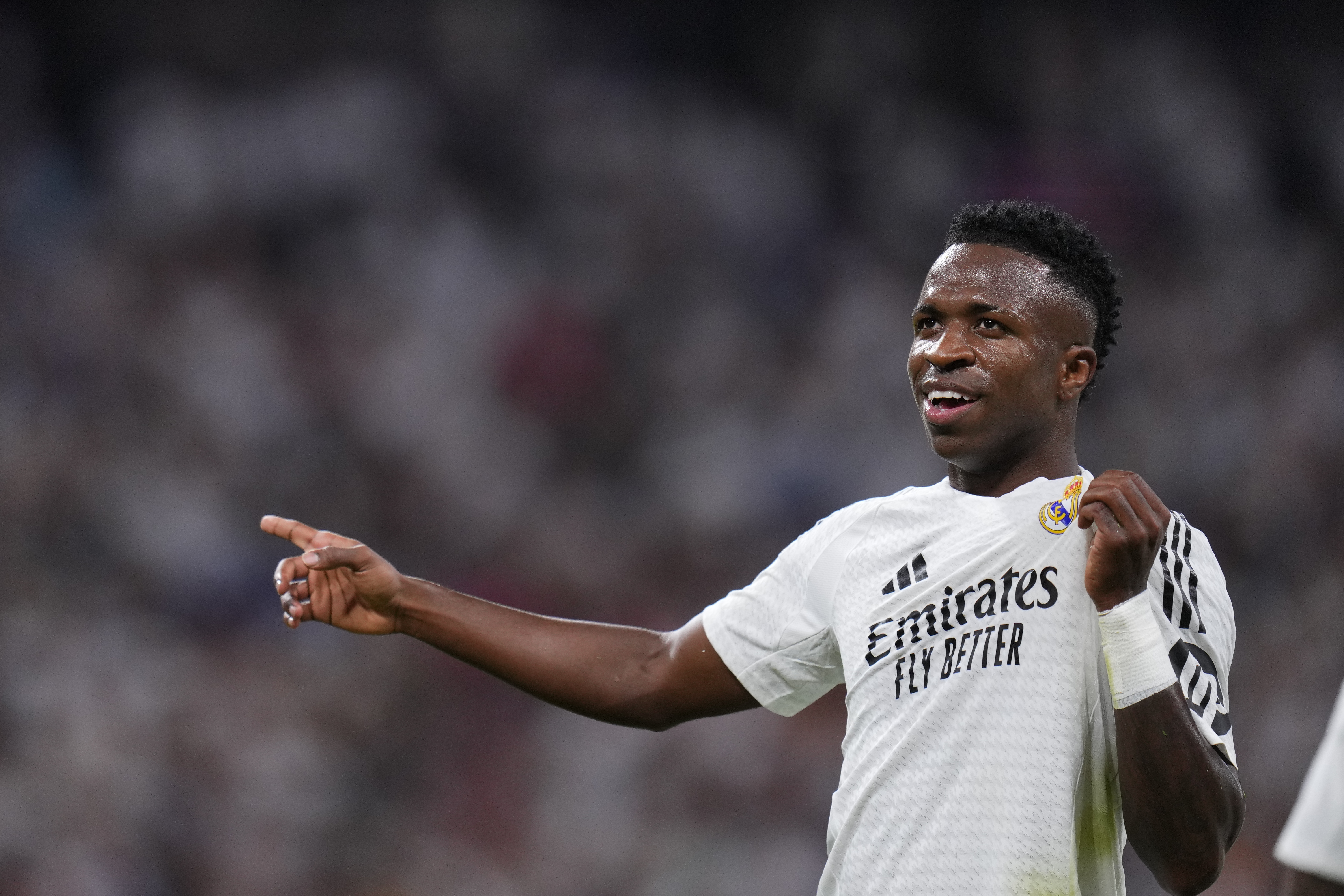 Real Madrid's Vinicius Junior, left, celebrates after he scored his team's third goal against Espanyol during a Spanish La Liga soccer match at Santiago Bernabeu stadium in Madrid, Spain, Saturday, Sept. 21, 2024.