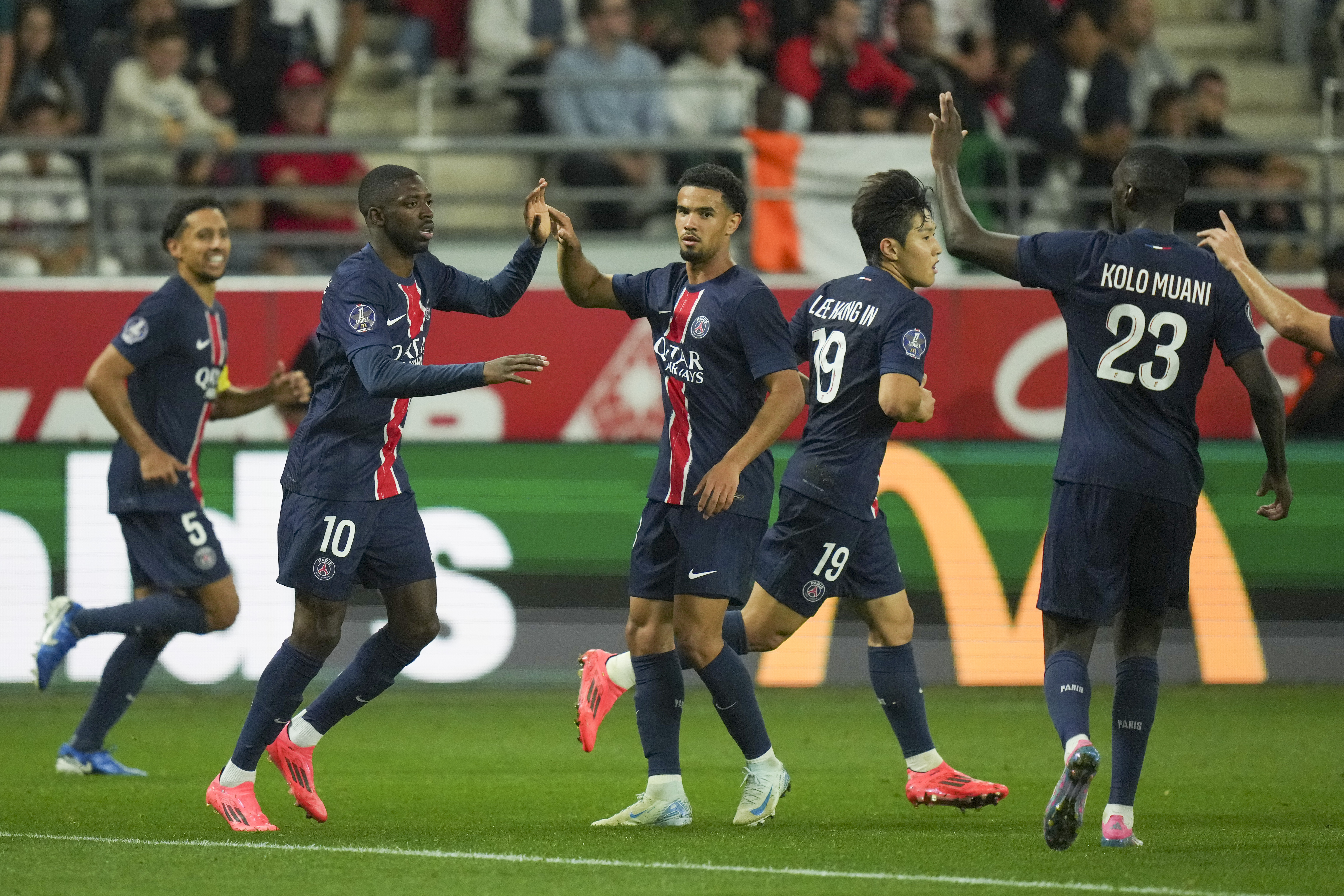 PSG's Ousmane Dembele, second from left, is congratulated after scoring his side's first goal during the French League One soccer match between Reims and Paris Saint-Germain at the the Stade Auguste-Delaune in Reims, eastern France, Saturday, Sept. 21, 2024.