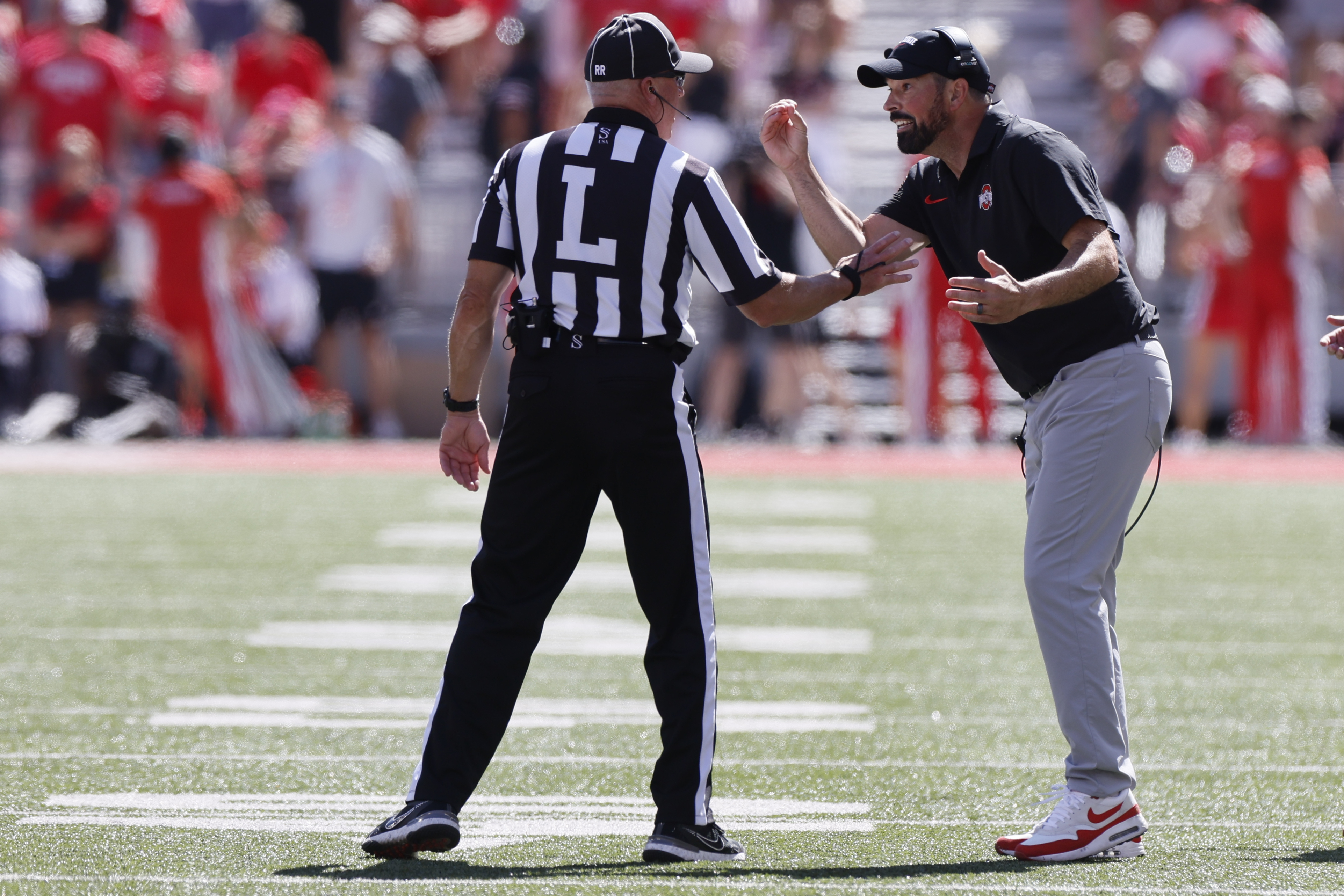 Ohio State head coach Ryan Day, right, argues with the linesman during the second half of an NCAA college football game against Marshall, Saturday, Sept. 21, 2024, in Columbus, Ohio. 