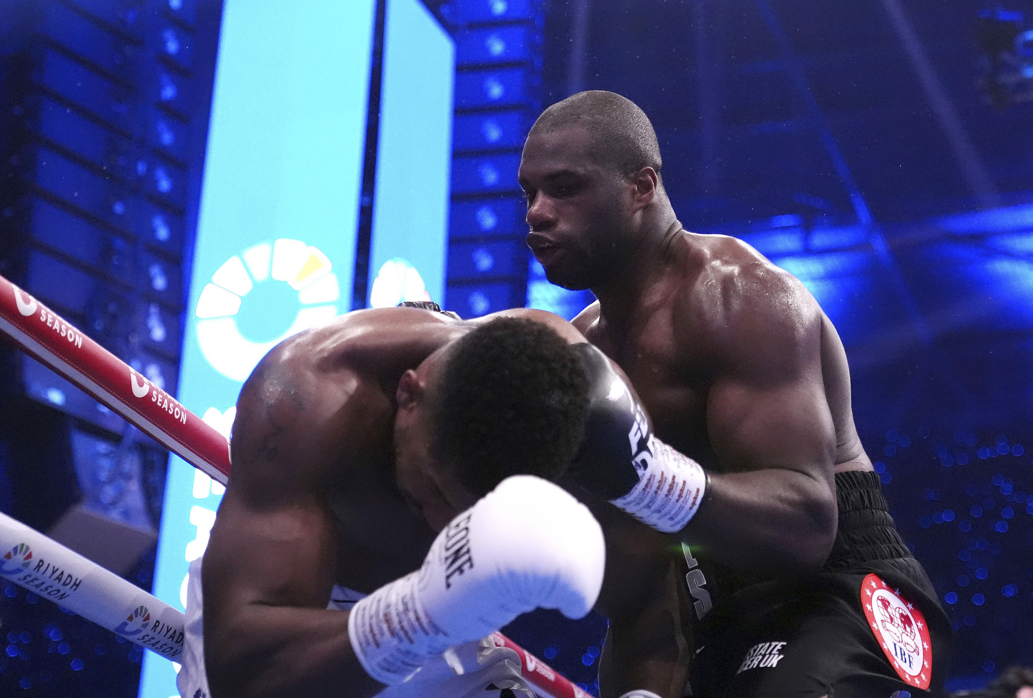 Daniel Dubois, right, knocks down Anthony Joshua in the IBF World Heavyweight bout at Wembley Stadium, in London, Saturday Sept. 21, 2024. 
