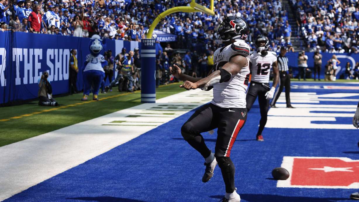 Houston Texans running back Joe Mixon (28) celebrates a touchdown during the second half of an NFL football game against the Indianapolis Colts, Sunday, Sept. 8, 2024, in Indianapolis.