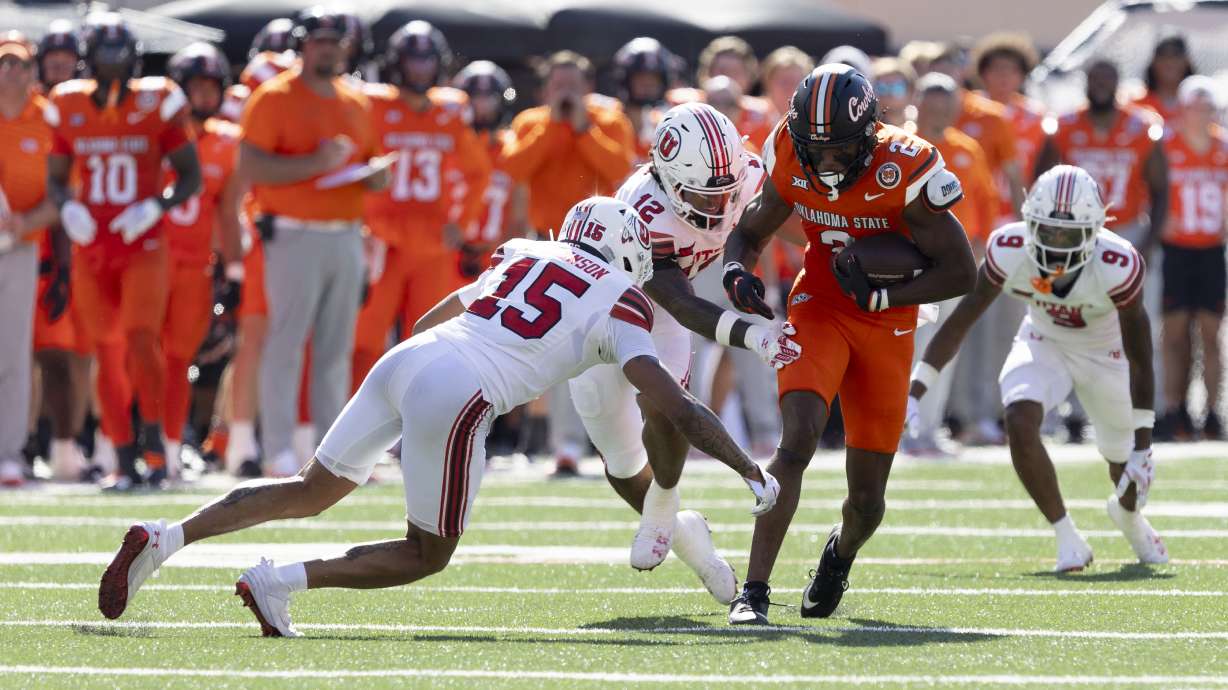 Oklahoma State wide receiver Talyn Shettron (2) runs past Utah linebacker Sione Fotu (12) and safety Tao Johnson (15) in the first half of an NCAA college football game Saturday, Sept. 21, 2024, in Stillwater, Okla.