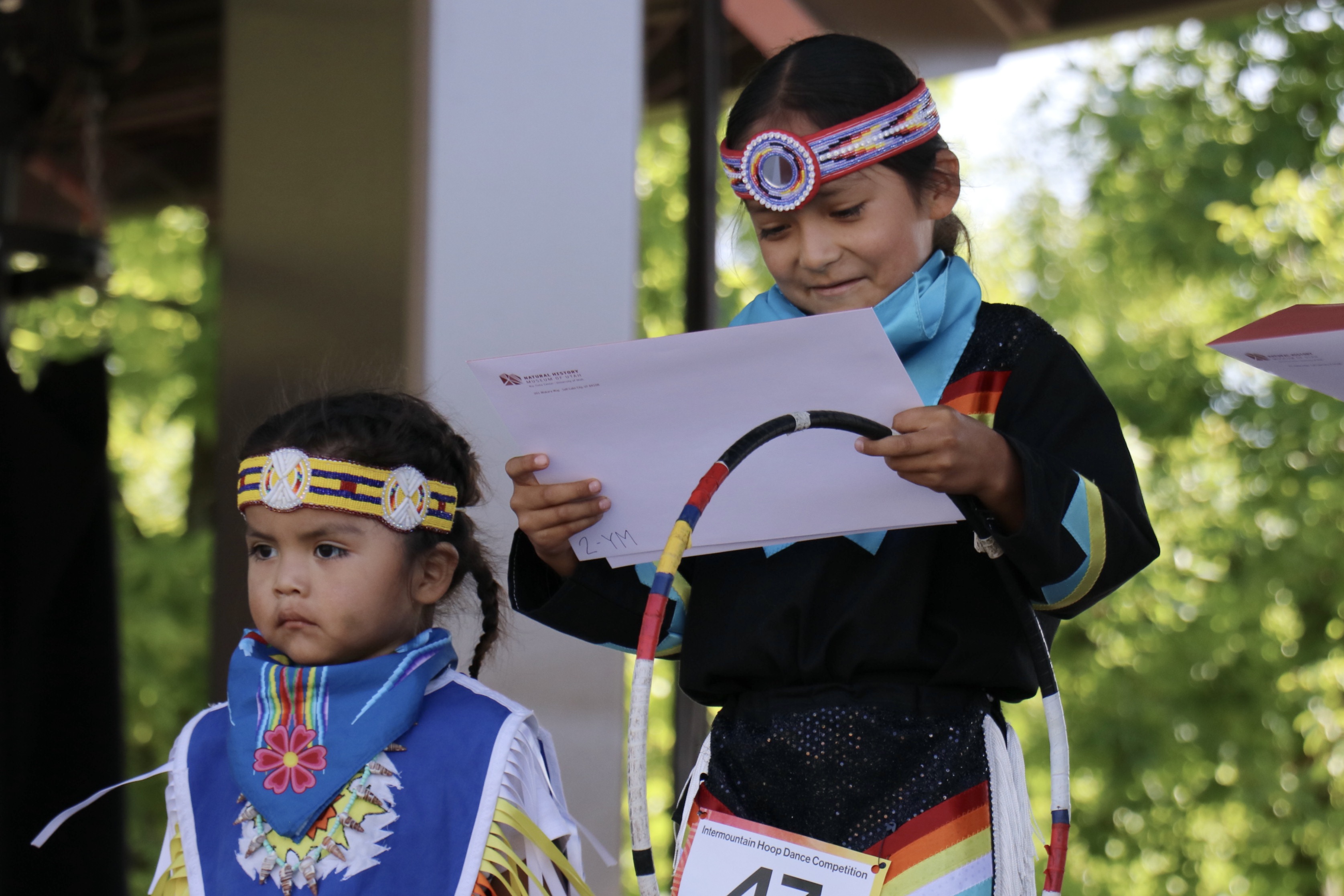 Jaden Secody looked at his 2nd place certificate during the inaugural Intermountain Hoop Dance Competition at Red Butte Garden, in Salt Lake City, on Saturday.