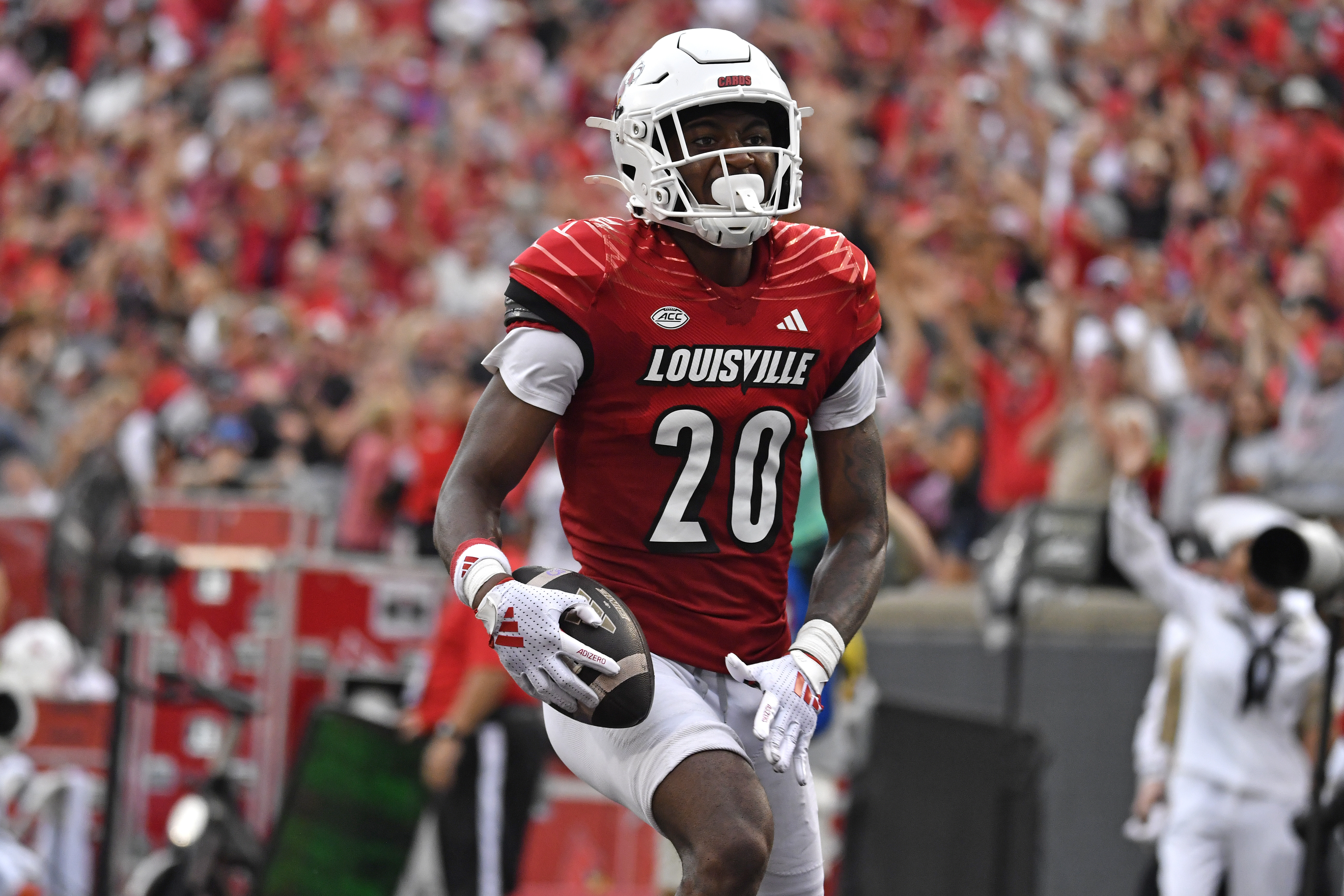 Louisville defensive back Tayon Holloway (20) runs into the end zone to score during the second half of an NCAA college football game against Georgia Tech in Louisville, Ky., Saturday, Sept. 21, 2024. 