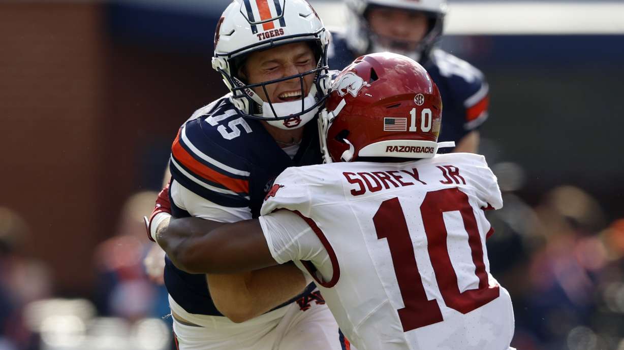 Auburn quarterback Hank Brown (15) is tackled by Arkansas linebacker Xavian Sorey Jr. (10) as he carries the ball during the first half of an NCAA college football game, Saturday, Sept. 21, 2024, in Auburn, Ala.