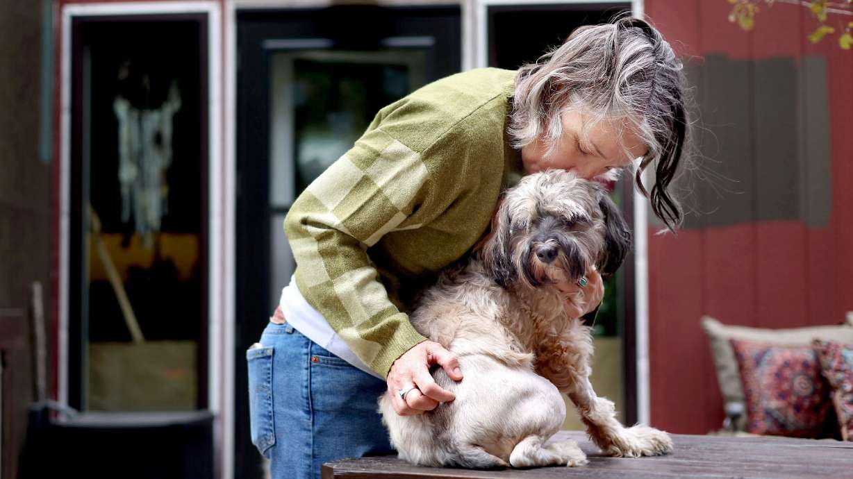 Whitney Weiss kisses Stella at her home in Oakley on Sept. 12. The Weisses have spent over $10K in medical bills on Stella’s recovery treatment since she was hit by a car on their property.