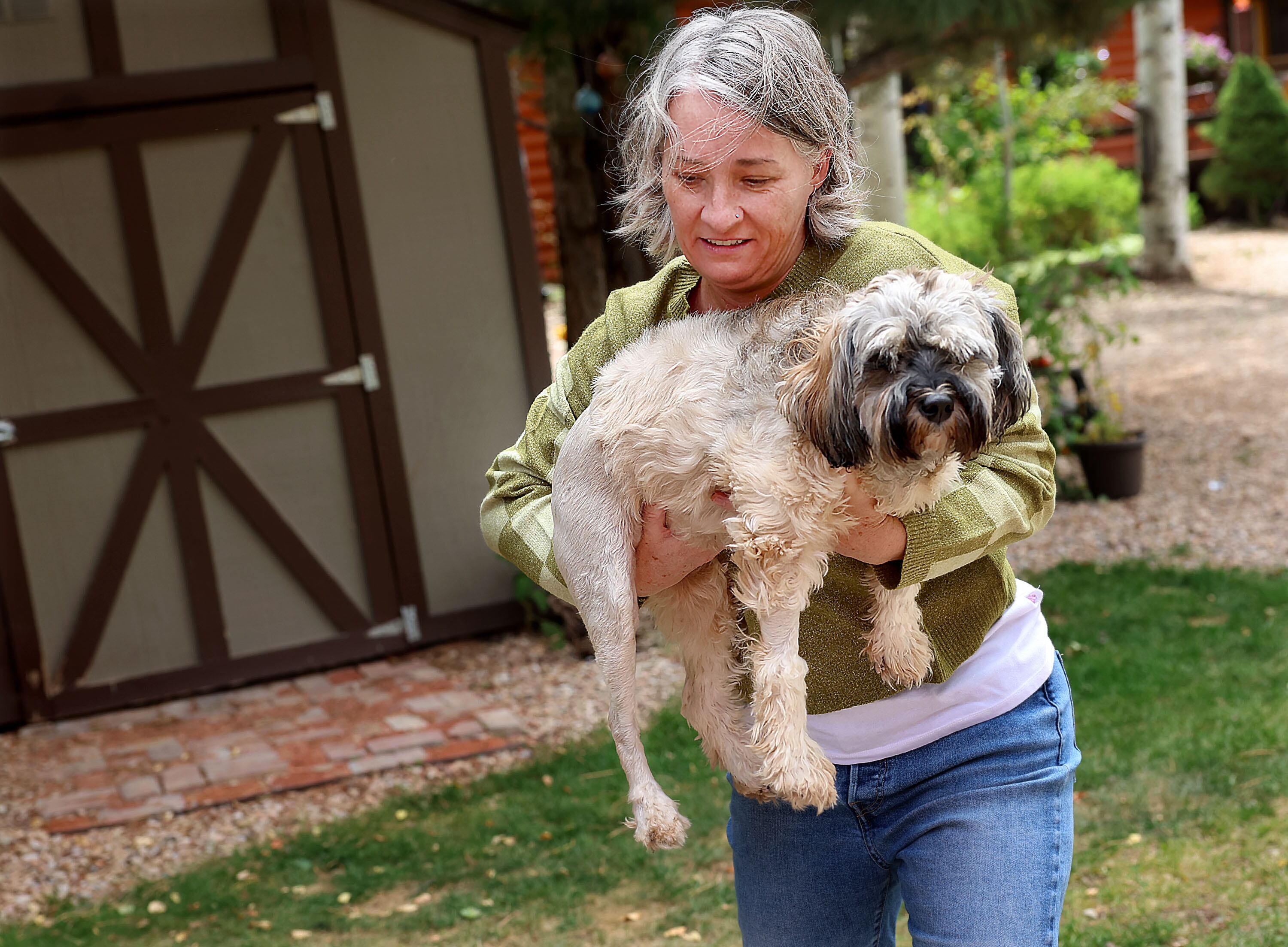 Whitney Weiss carries Stella at her home in Oakley on Sept. 12. The Weisses have spent over $10K in medical bills on Stella’s recovery treatment since she was hit by a car on their property.