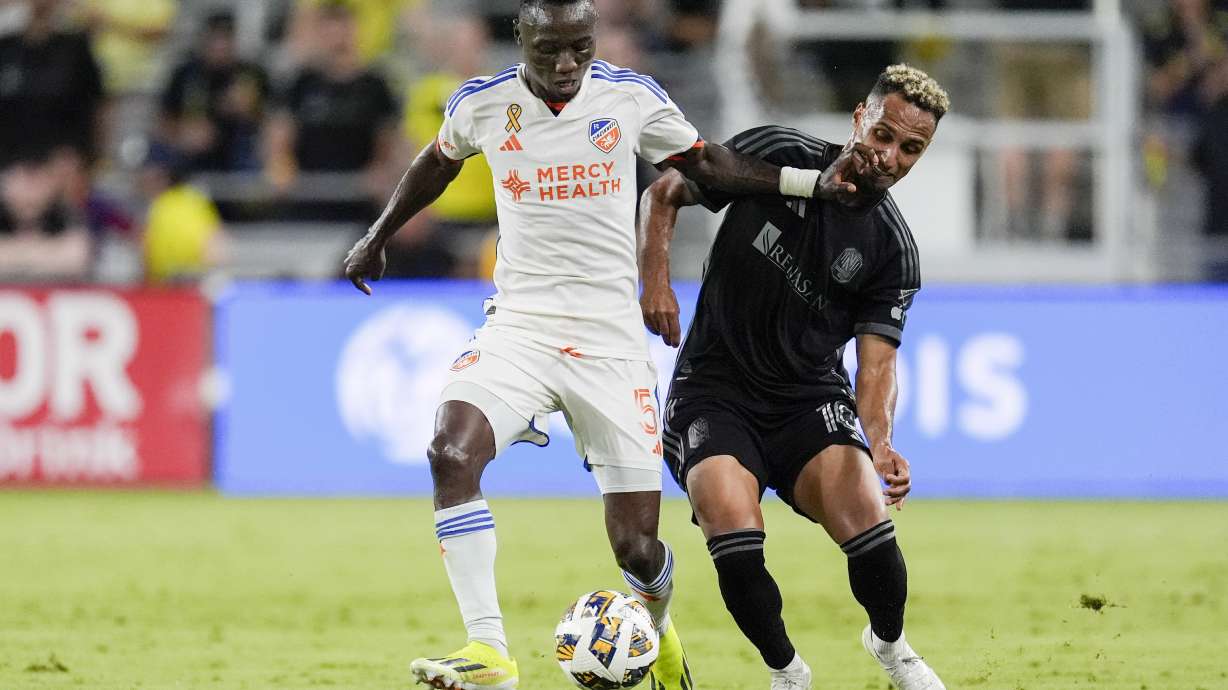 FC Cincinnati midfielder Obinna Nwobodo (5) kicks the ball past Nashville SC midfielder Hany Mukhtar (10) during the second half of an MLS soccer match Saturday, Sept. 21, 2024, in Nashville, Tenn.