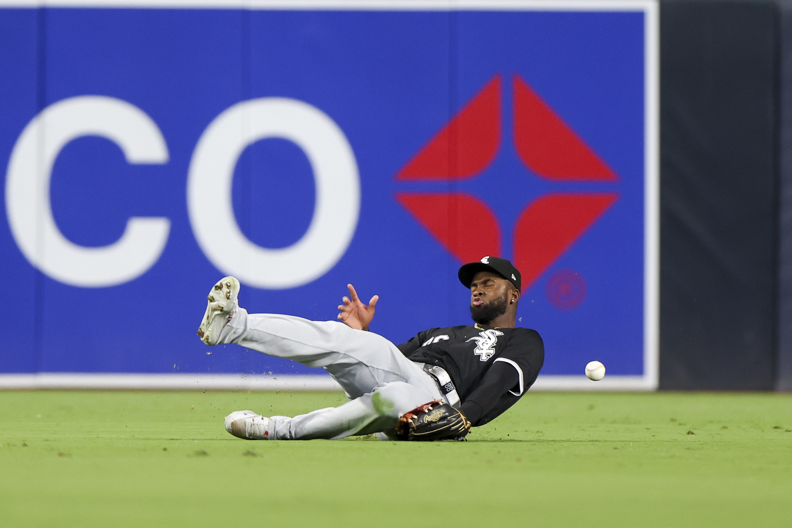 Chicago White Sox center fielder Luis Robert Jr. is unable to handle a double hit by San Diego Padres' Jurickson Profar during the fifth inning of a baseball game, Saturday, Sept. 21, 2024, in San Diego. 