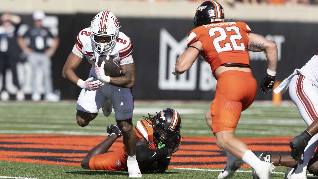 Utah running back Micah Bernard (2) runs past Oklahoma State cornerback Cam Smith (3) in the first half of an NCAA college football game Saturday, Sept. 21, 2024, in Stillwater, Okla.