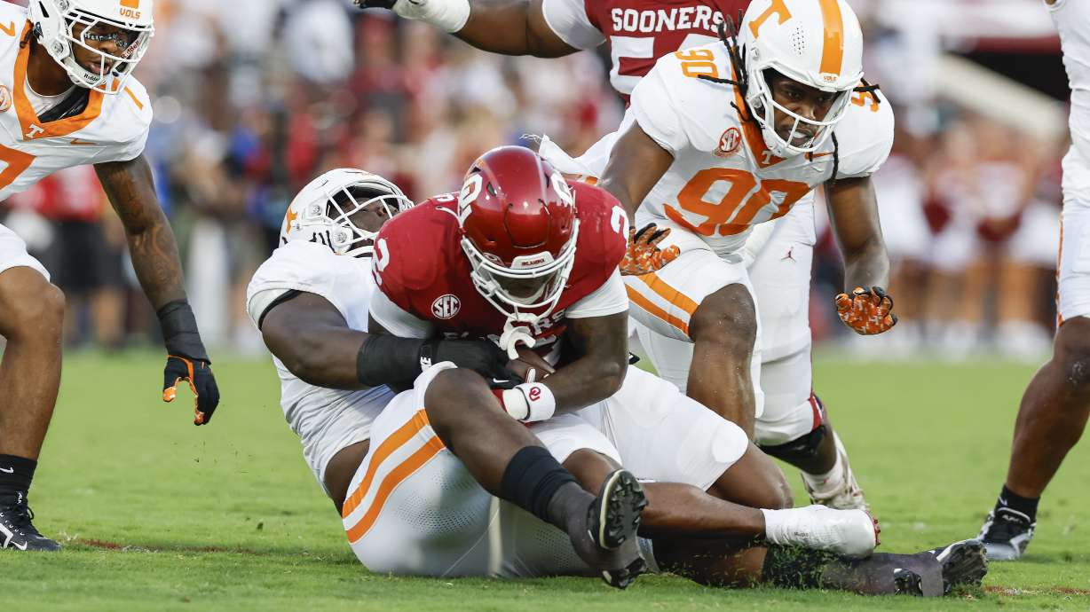 Tennessee defensive lineman Elijah Simmons tackles Oklahoma running back Jovantae Barnes during the first quarter of an NCAA college football game, Saturday, Sept. 21, 2024, in Norman, Okla.