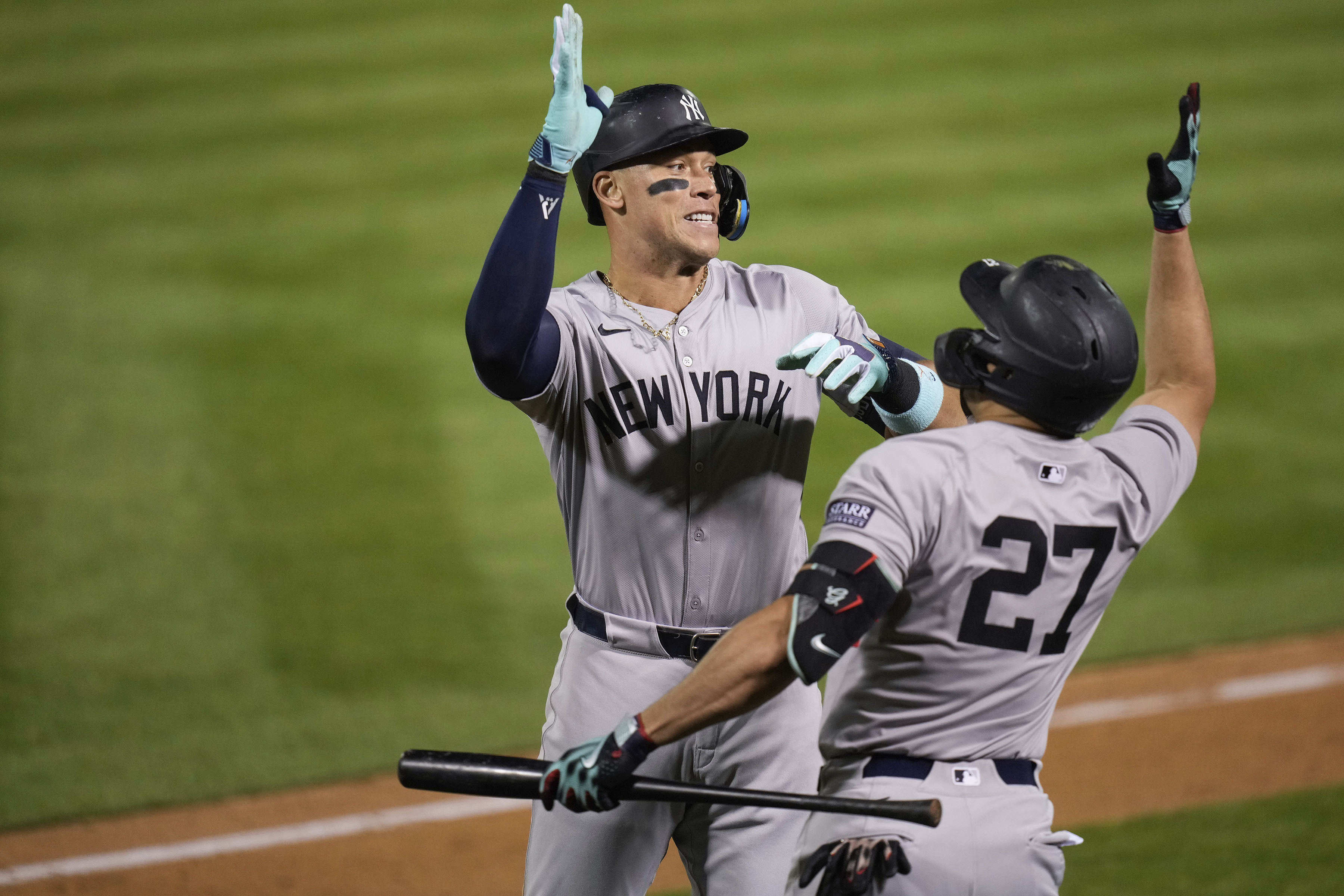 New York Yankees' Aaron Judge, left, celebrates with Giancarlo Stanton (27) after hitting a solo home run during the seventh inning of a baseball game against the Oakland Athletics, Saturday, Sept. 21, 2024, in Oakland, Calif.
